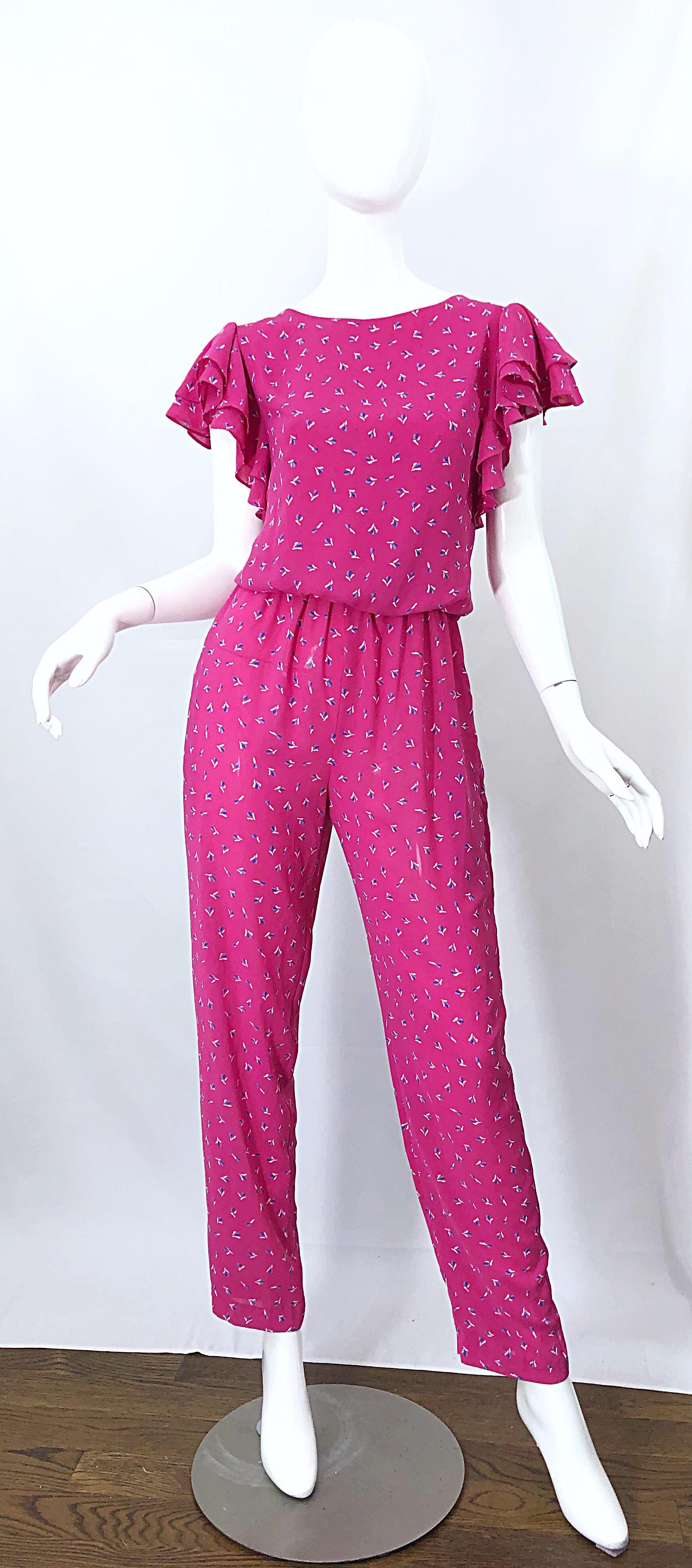 Amazing vintage early 1980s JODY T hot pink flower print straight leg jumpsuit! Features a loose fitting bodice with smart tailored legs. Hidden zipper up the back with button closure at neck. Chic ruffles at each sleeve. Pockets at each side of the