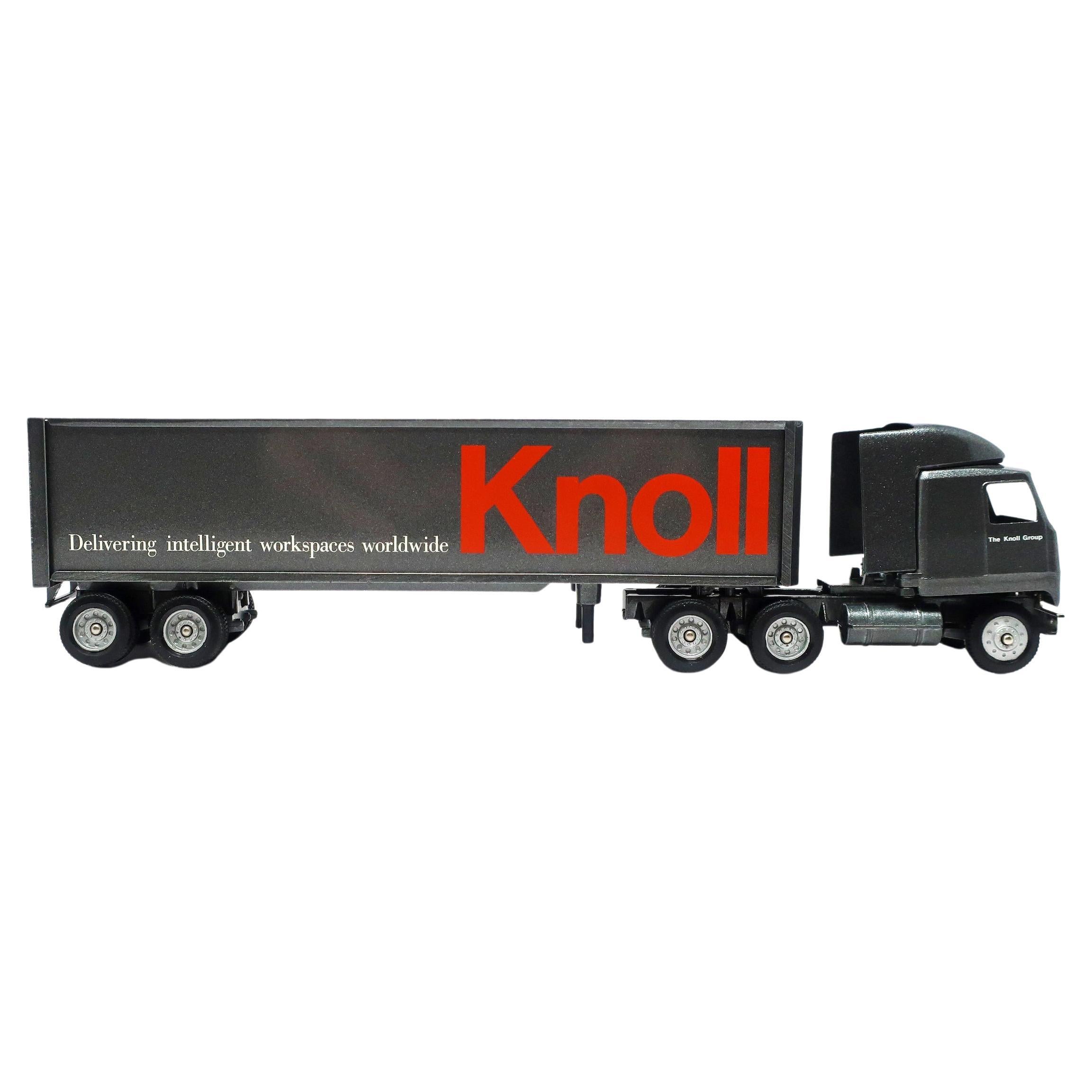 A fun Knoll Furniture miniature die-case truck made by Winross. Likely a collectible item given to Knoll employees, it is a 1:64 scale model with removable cab and trailer with metal and plastic parts. Charcoal grey paint on cab and trailer with