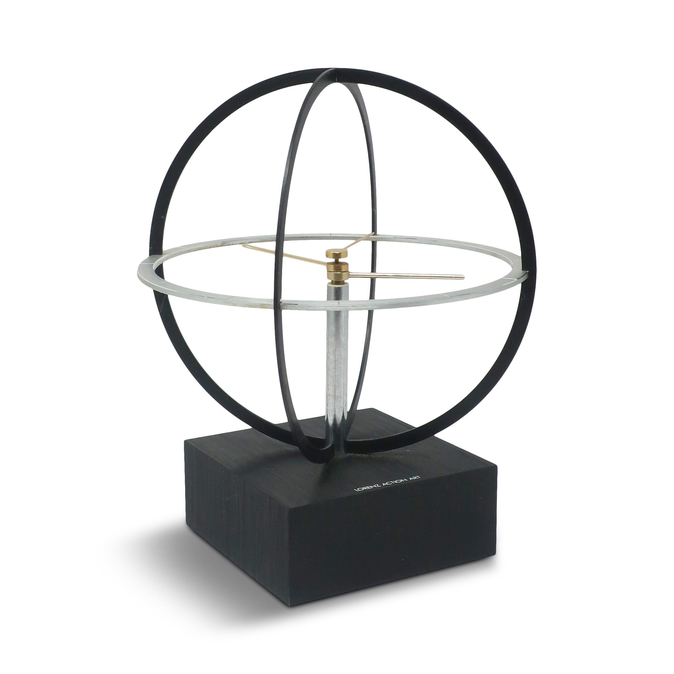 Bringing a touch of Space Age design flair to your space, this mid-century clock features a kinetic sphere design, with the clock's hands rotating within the chrome frame.  Cleverly designed so that it can both be used on a table as a desk clock and