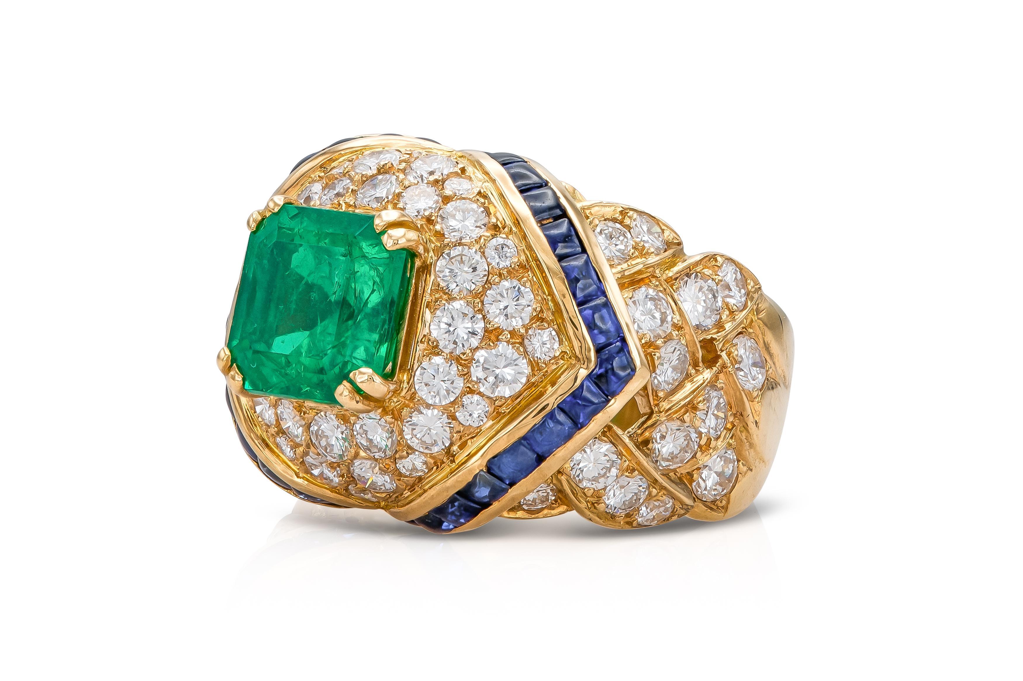 Finely crafted in 18k yellow gold with a Square Emerald cut Emerald weighing approximately 2.00 carats, 73 Round Brilliant cut Diamonds weighing approximately a total of 4.00. carats, and 30 Cabochon Sapphires weighing approximately a total of 1.50