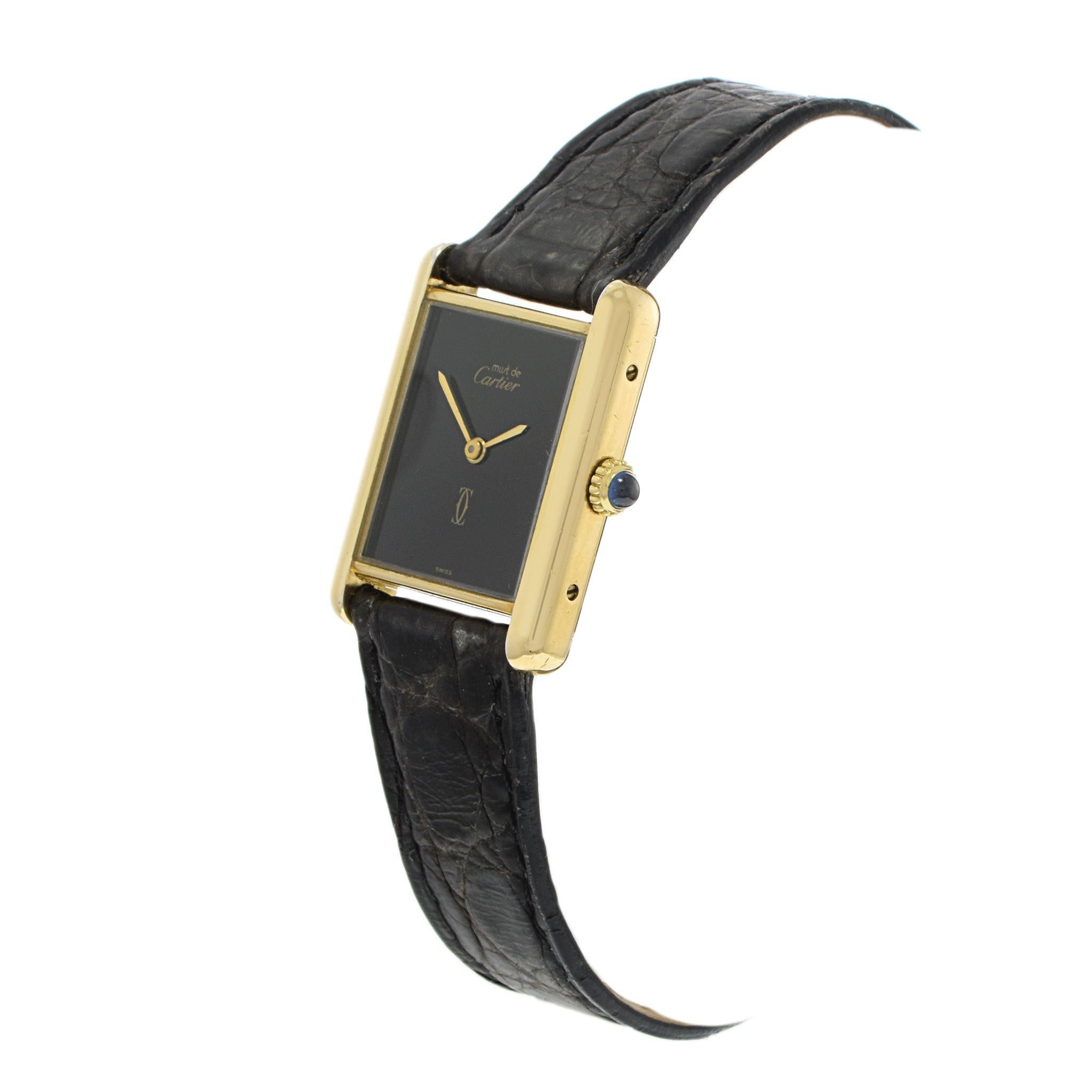 A striking rectangular watch from 1980 by Cartier.

Crafted in vermeil, this exquisite piece features an 18k gold-plated sterling silver case.

The watch face is minimalist, with elegant gold hands and a subtle logo detail.

The black leather