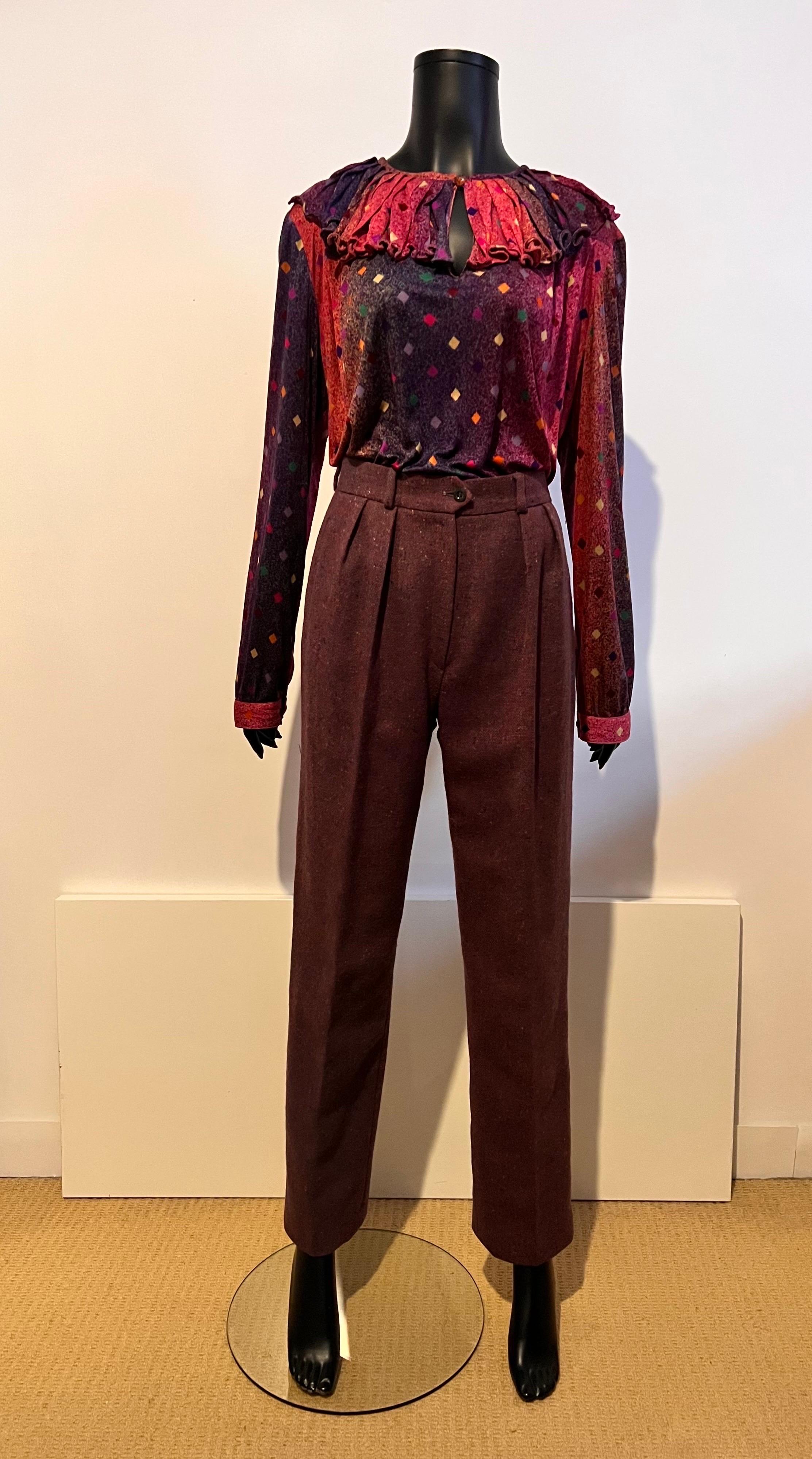 A beautiful example of the early 1980's Missoni design in these 100% Italian wool tweed, pleat front pants in a stunning colour combination showing an overall muted purple colour with flecks of orange, blue and lilac.

Beautiful welted pockets on