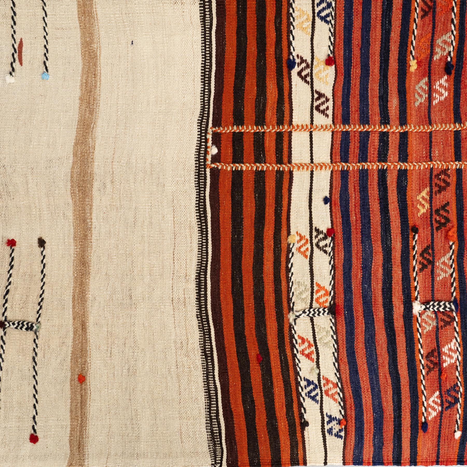 This stunning vintage Moroccan rug, handmade with care around the 1980s, exudes warmth and authenticity. Crafted from premium-quality wool, it features a captivating blend of orange and natural beige colors that bring vibrancy and sophistication to