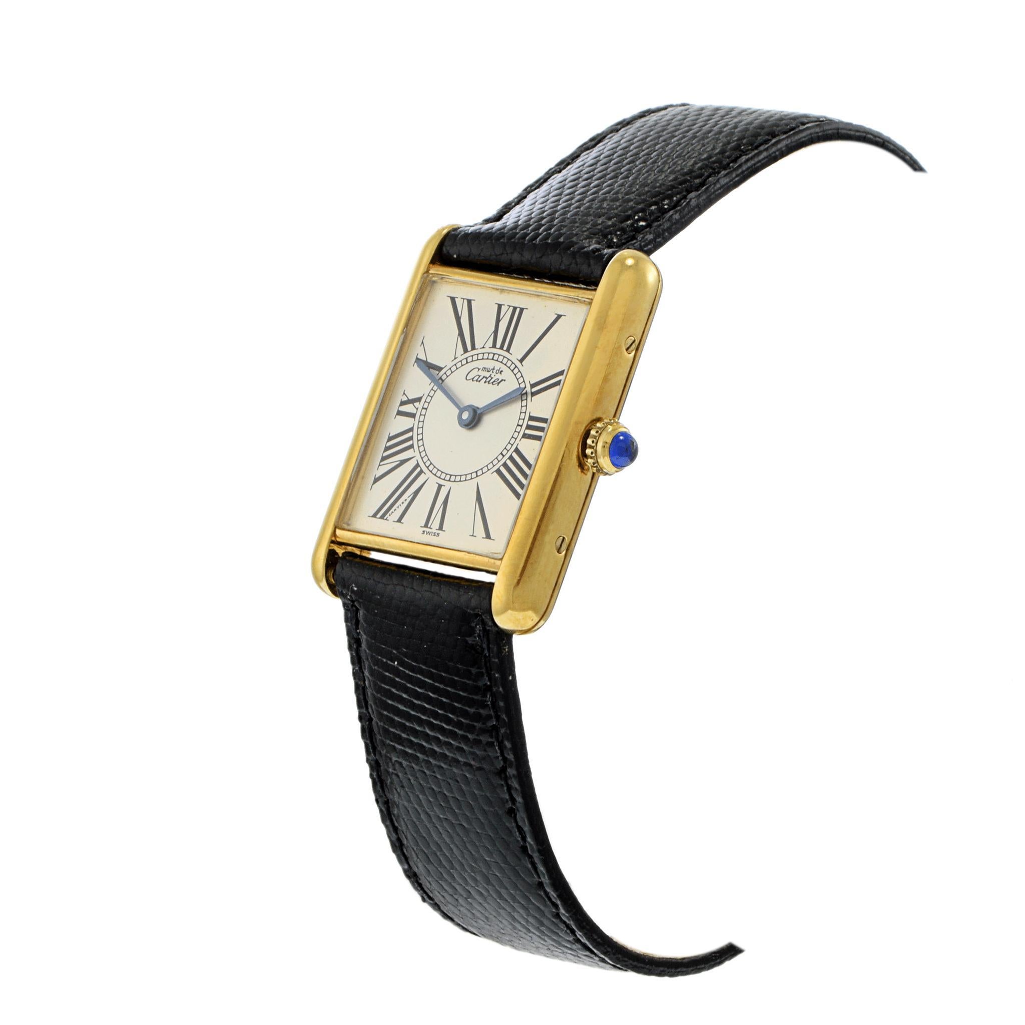 A study in elegance, precision, and timeless design.

This striking Cartier watch features a classic rectangular face adorned with bold Roman numerals. The quartz movement ensures precise timekeeping, while the vermeil and Sterling silver case adds