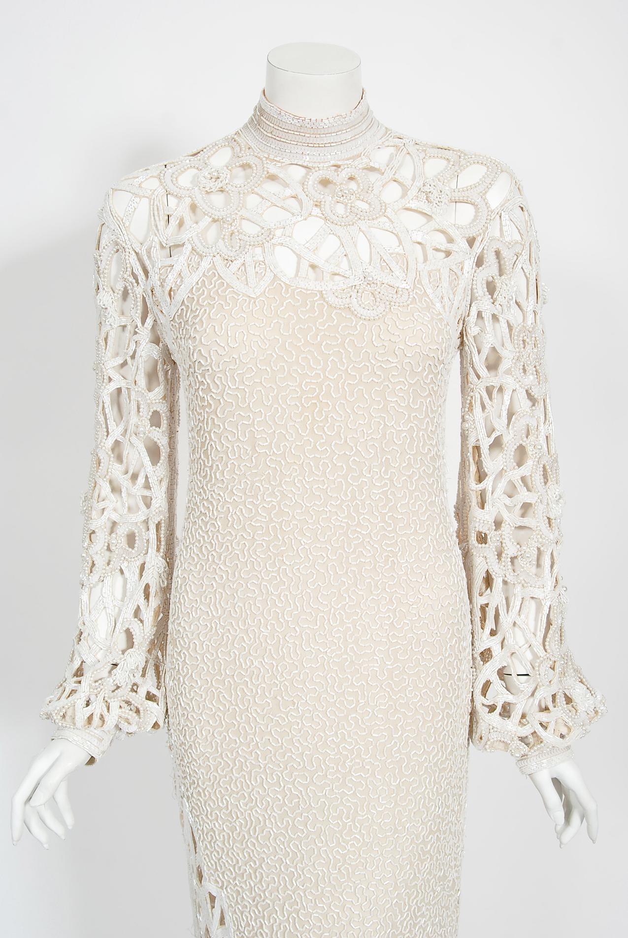 An ultra chic and totally unique Naeem Khan fully-beaded ivory silk gown dating back to the early 1980's. In 1978, Khan moved to the United States to apprentice for legendary American designer Halston. During this time, he mastered the art of