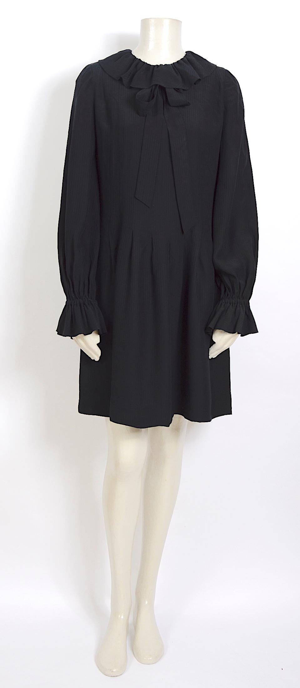 Nina Ricci dress made in black soft silk. Features a ruffle collar with a silk fabric ribbon bow underneath. 
Lined fully with silk lining.
Size label missing, please go by the provided measurements.
Sh to Sh 14inch/36cm - Ua to Ua 19inch/48cm(x2) -