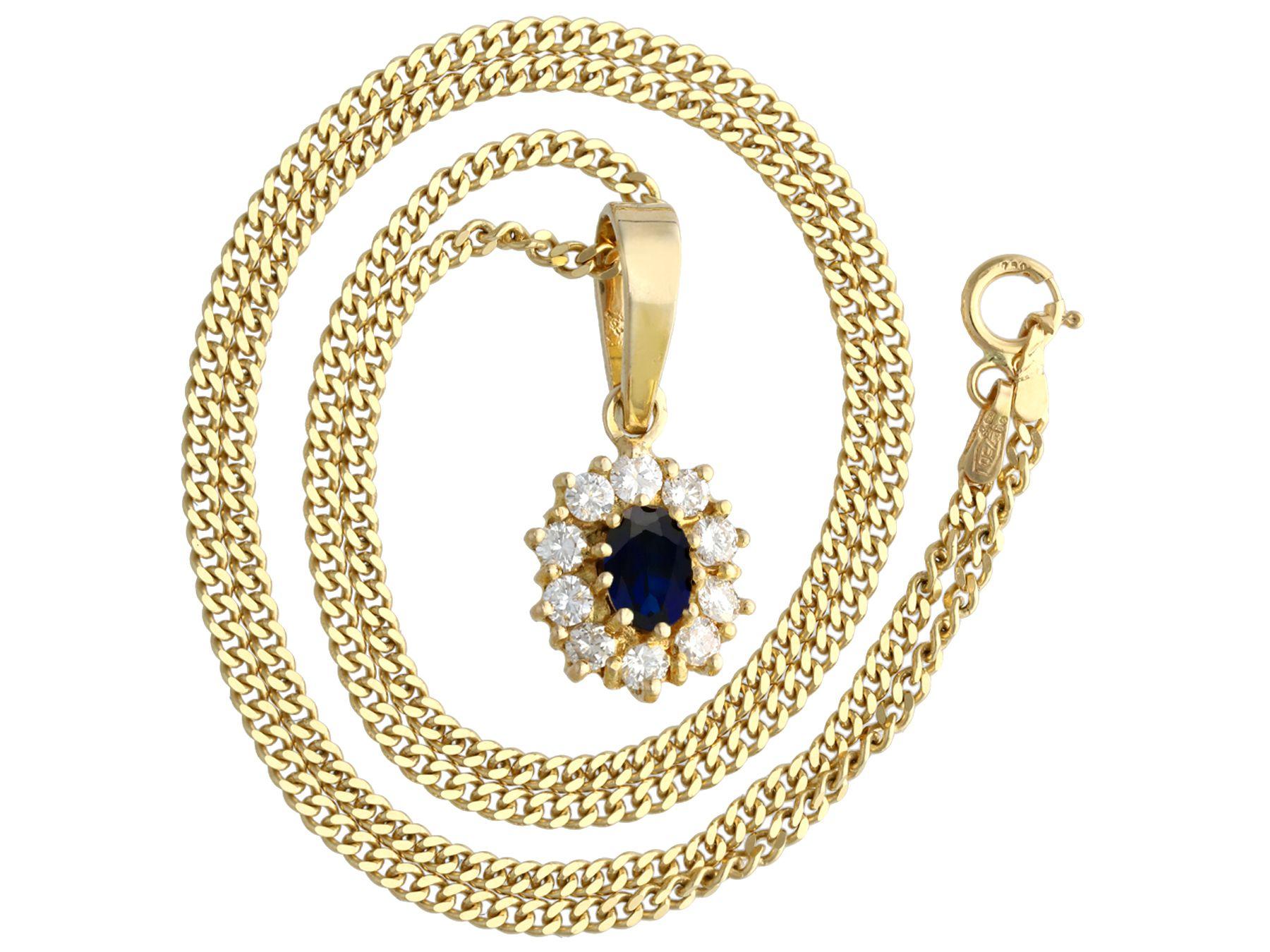 An impressive vintage 0.62 carat blue sapphire and 0.35 carat diamond, 18 karat yellow gold cluster pendant; part of our diverse gemstone jewelry collections.

This fine and impressive oval cut blue sapphire and diamond pendant has been crafted in