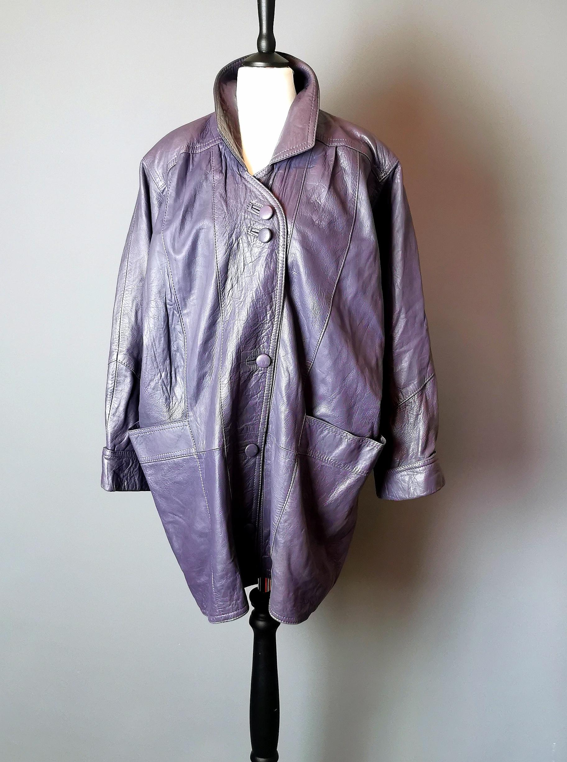 A superb original 80s oversized leather jacket.

This real leather jacket has everything 80s in it's design, from the chunky frame to the colour pop of the purple.

It fastens with leather covered buttons and is fully lined.

Labelled inside for