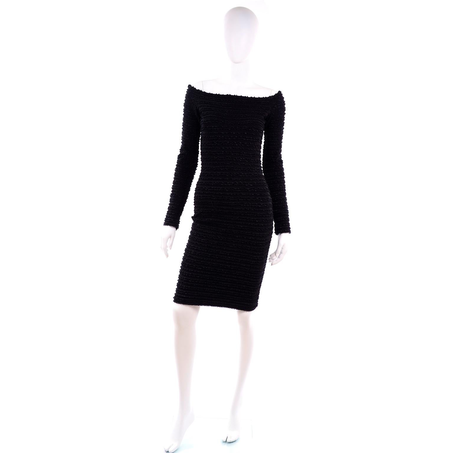 This is a 1988 black Patrick Kelly stretch bodycon dress with textured ruffle details horizontally across the entire dress. This wonderful 1980's dress has long sleeves and a scoop neck and back. This mini dress hem hits mid thigh and is marked a