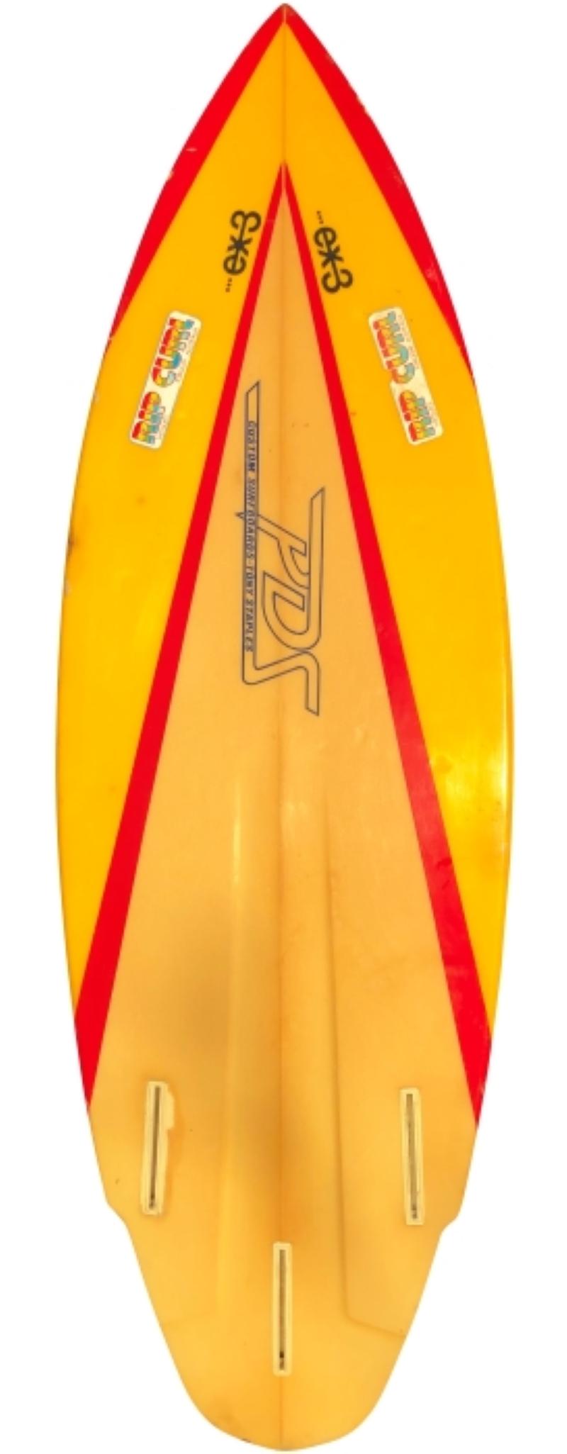 Mid-1980s PDS custom surfboards shortboard shaped by Tony Staples. Features a red/yellow color scheme with winged round tail shape. An affordable example of a 1980s vintage surfboard in all original condition.