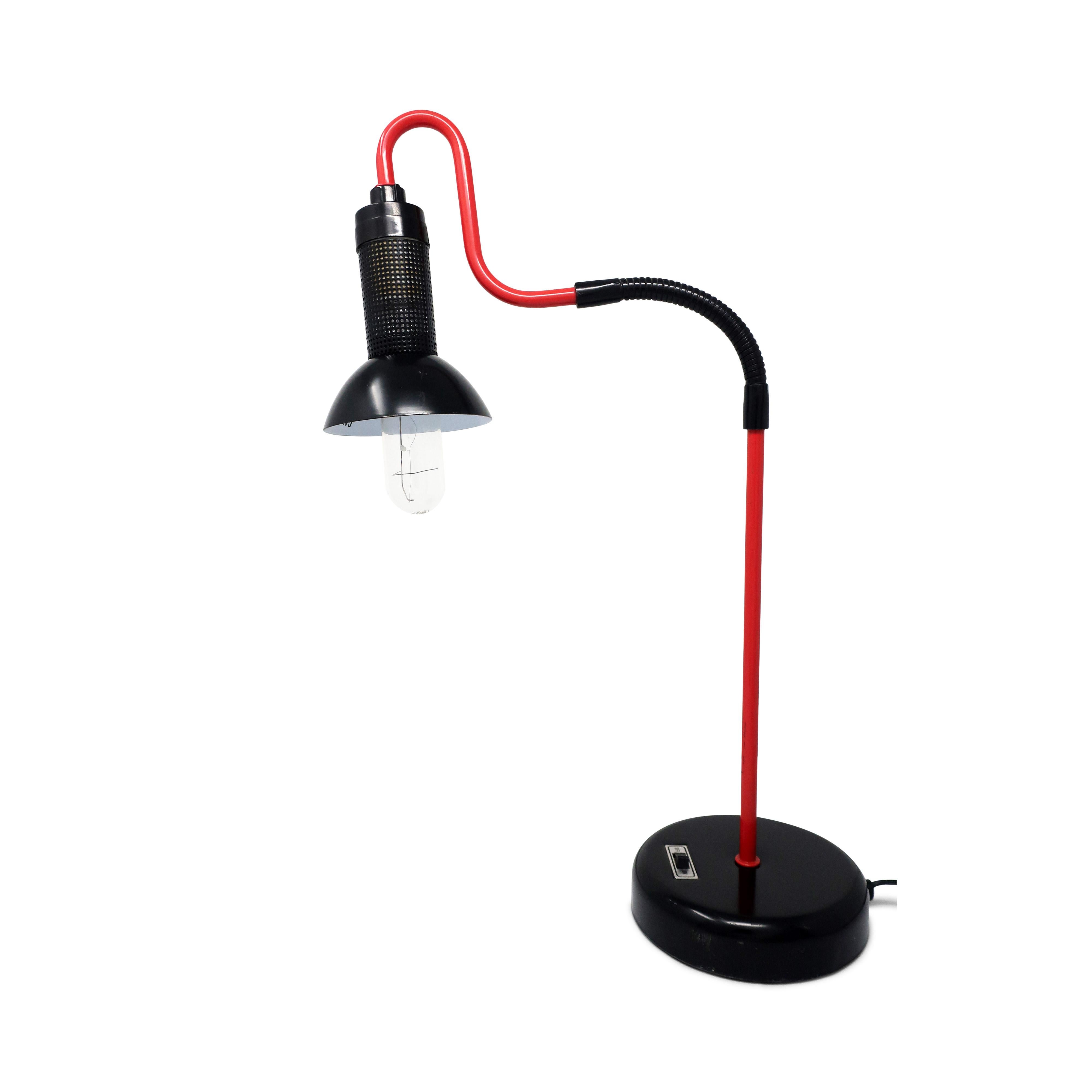 A charming desk lamp in the style of Ron Rezek with a perforated metal shade and a hump that gives it a ton of personality. Black shade, base, and gooseneck contrast perfectly with the red stem. On/off switch is on the base. In excellent vintage