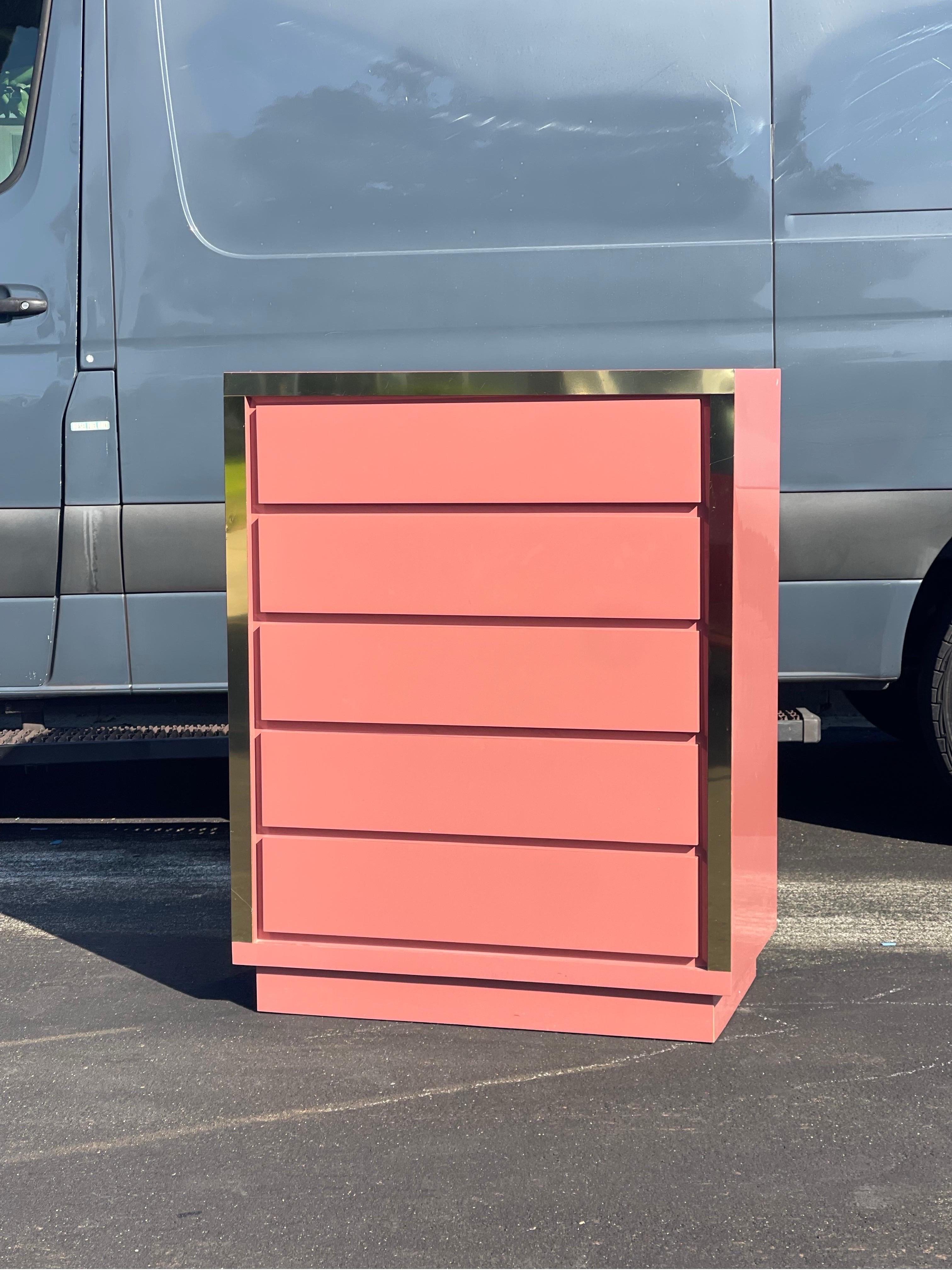 Add a pop of color with this stunning original 1980s pink dresser with brass detail. All drawers glide very smoothly. Age considering, it’s in beautiful condition. Minimal wear. Very small chip on the back bottom corner. 