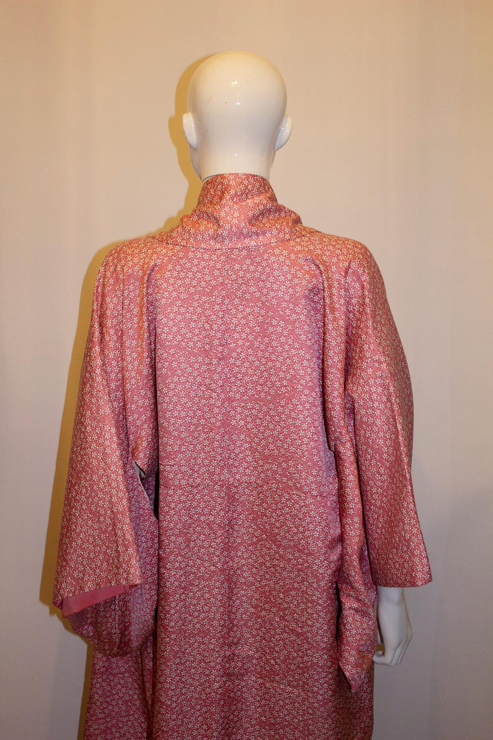 A pretty vintage silk kimono from Kyoto. The kimono is decorated with a pretty pattern of pink sakura blossom.  Measurements; Bust up to 50'', length 63''