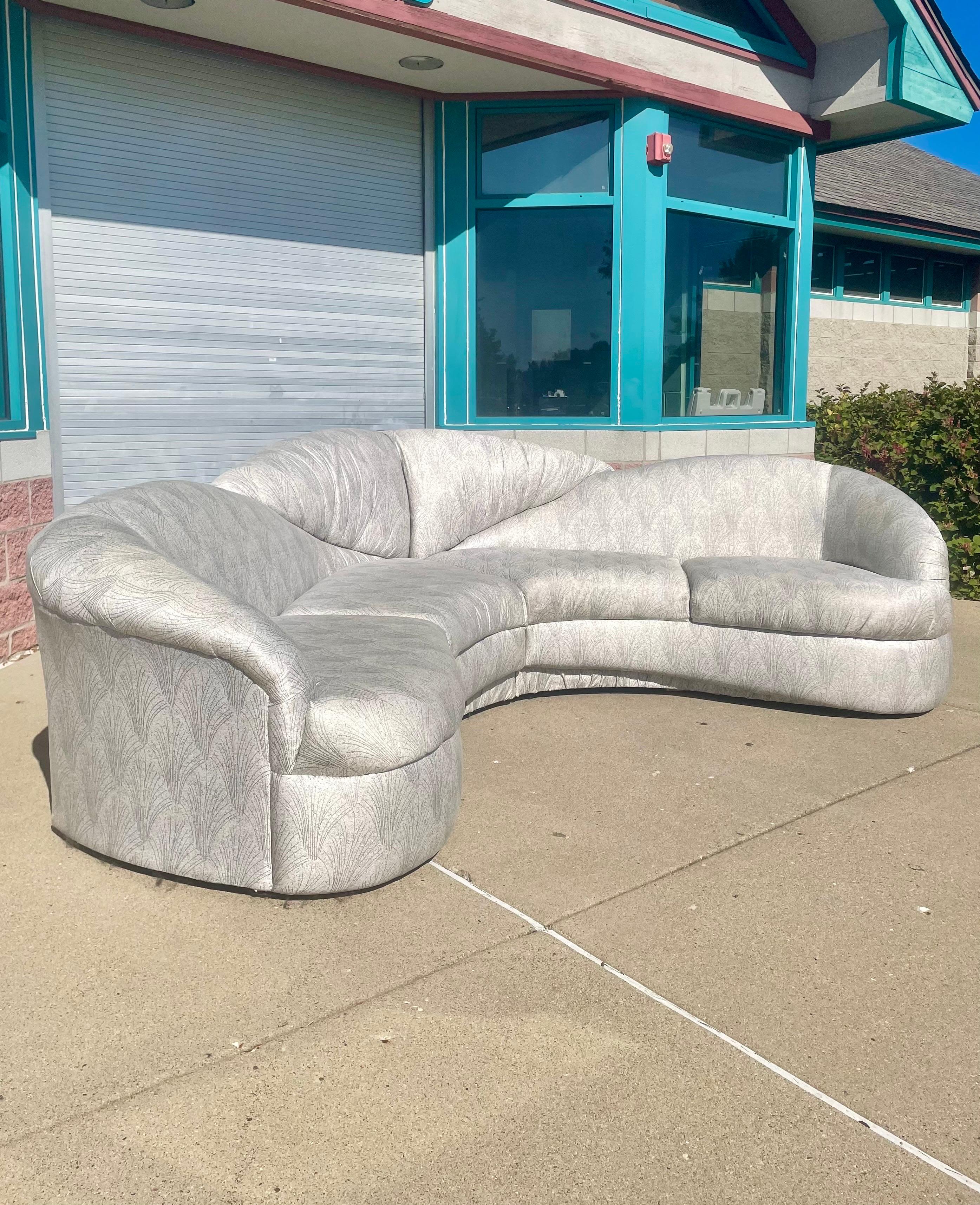 Unique custom gray curved sectional sofa chaise. A vintage beauty sure to make an impactful statement in any interior space. Upholstery fabric features a lovely pattern set in a gray color-way.