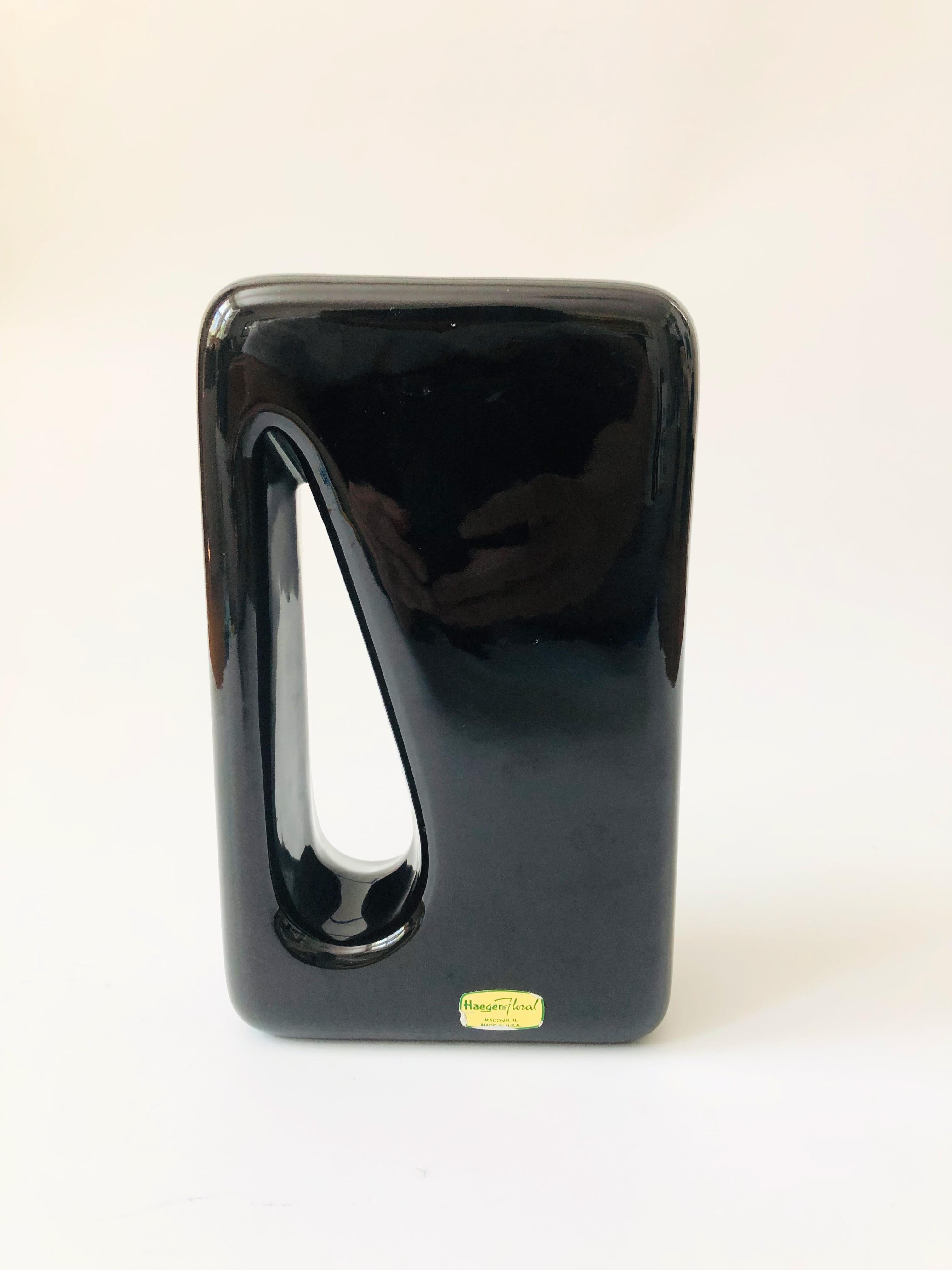A vintage 1980s ceramic vase by Haeger. Rectangular shape with a cutout design on one side. Finished in a glossy black glaze. A great sculptural accent piece.
 