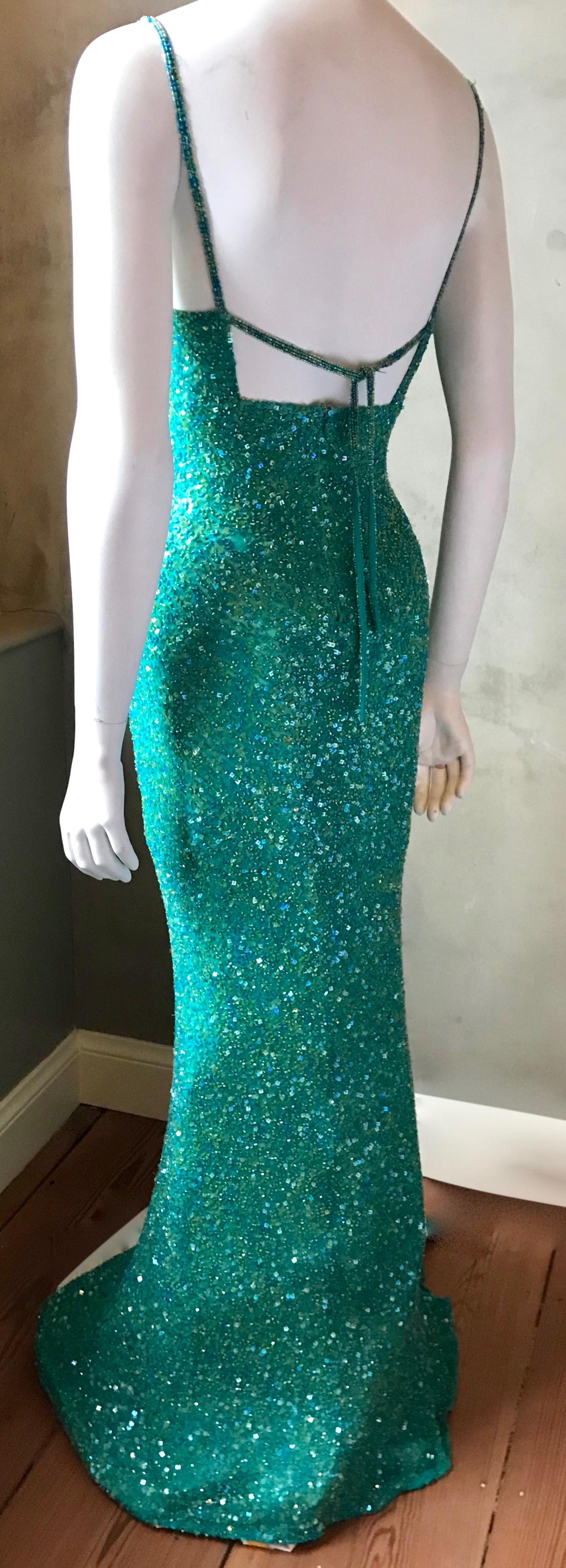 Full length 1980's Scala hand beaded silk gown. Absolutely striking opalescent teal/ /turquoise green chiffon silk covered in thousands of glass beads that are all sewn on by hand. Rich sexy and elegant style that Scala gowns are famous for.