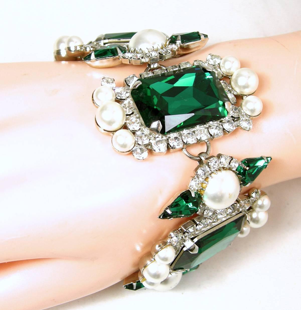 This vintage bracelet is magnificent and looks like it came out of the Queen’s Tower of London.   There are five links with large emerald green crystals in the center and bordered with beautiful faux pearls on the cop and bottom and clear crystal on