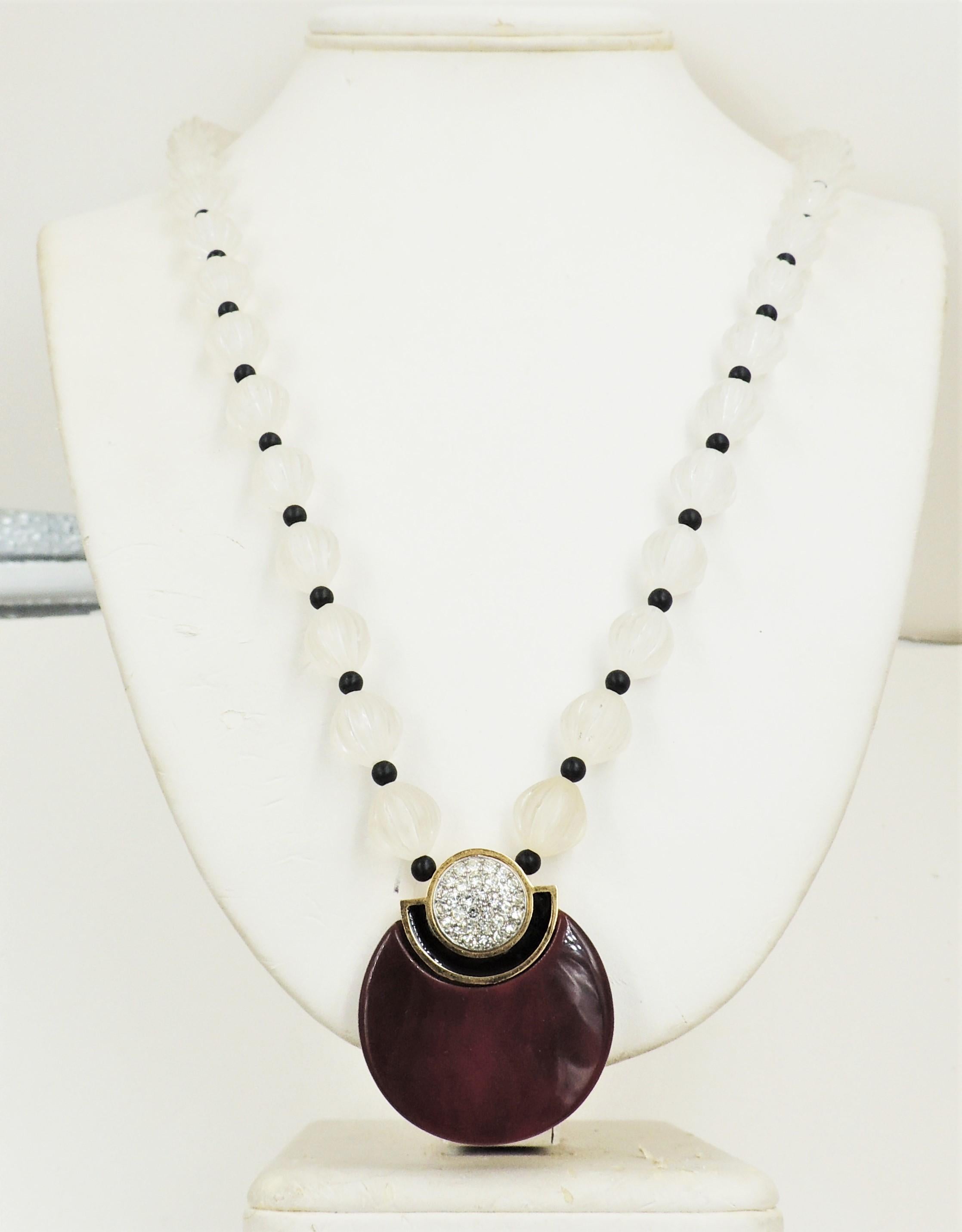 1980s Deco style maroon red/brown Lucite with black enamel and clear pave rhinestones pendant with frosted clear melon beads and black bead spacers necklace with gg fold over clasp. Marked 