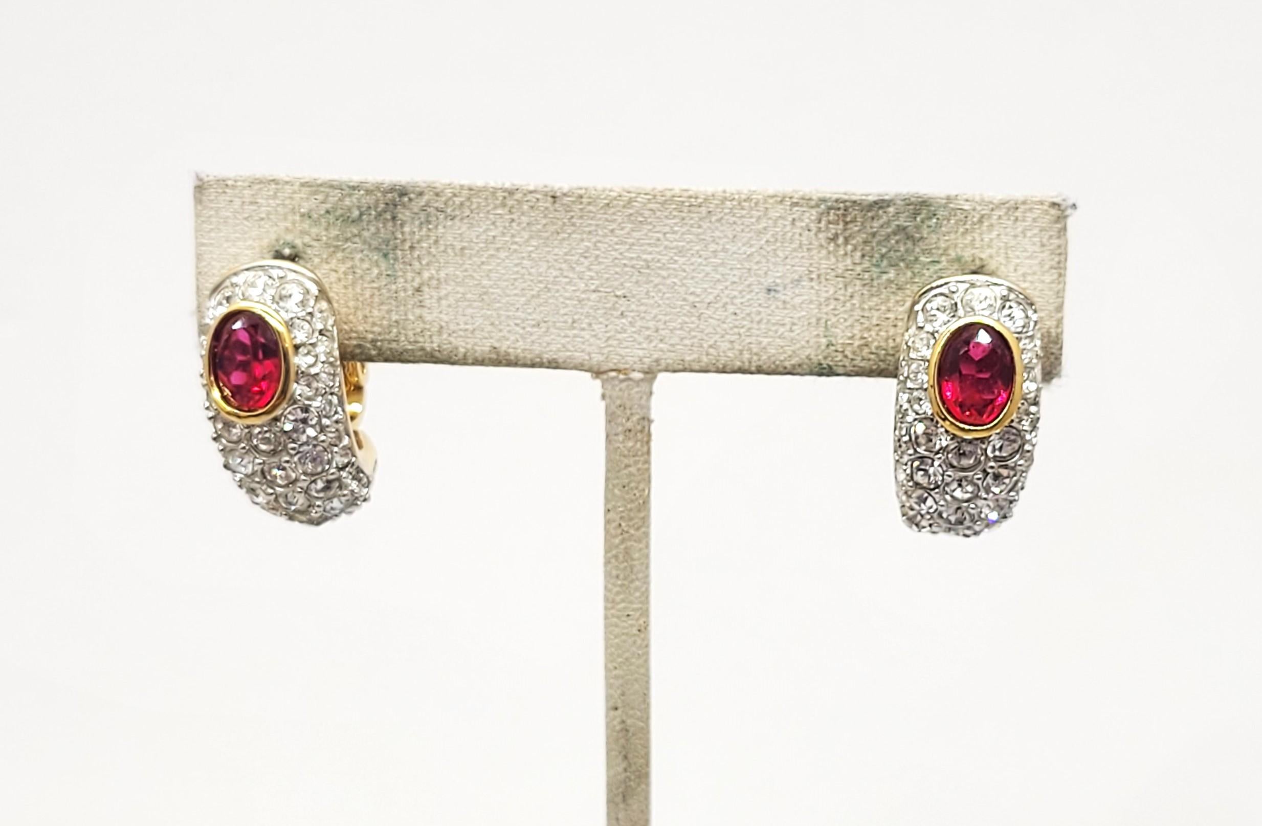 1980s goldtone pavé round clear rhinestones with unfoiled open backed oval faux-ruby half hoop pierced with clips to hold them in place earrings. Marked 