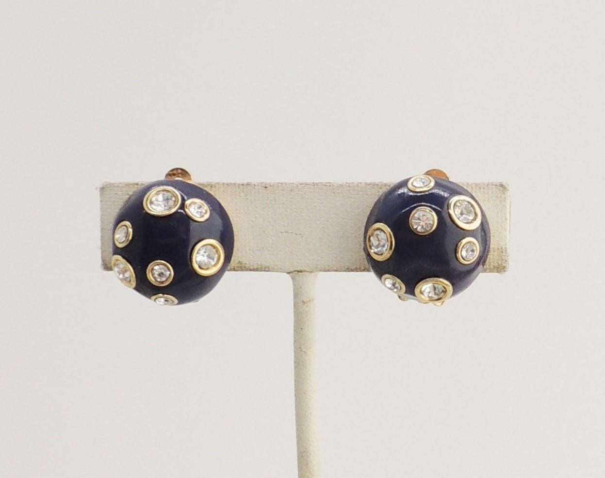 Goldtone round domed navy enamel with clear rhinestones clip earrings. Marked with Valentino Garavani's 