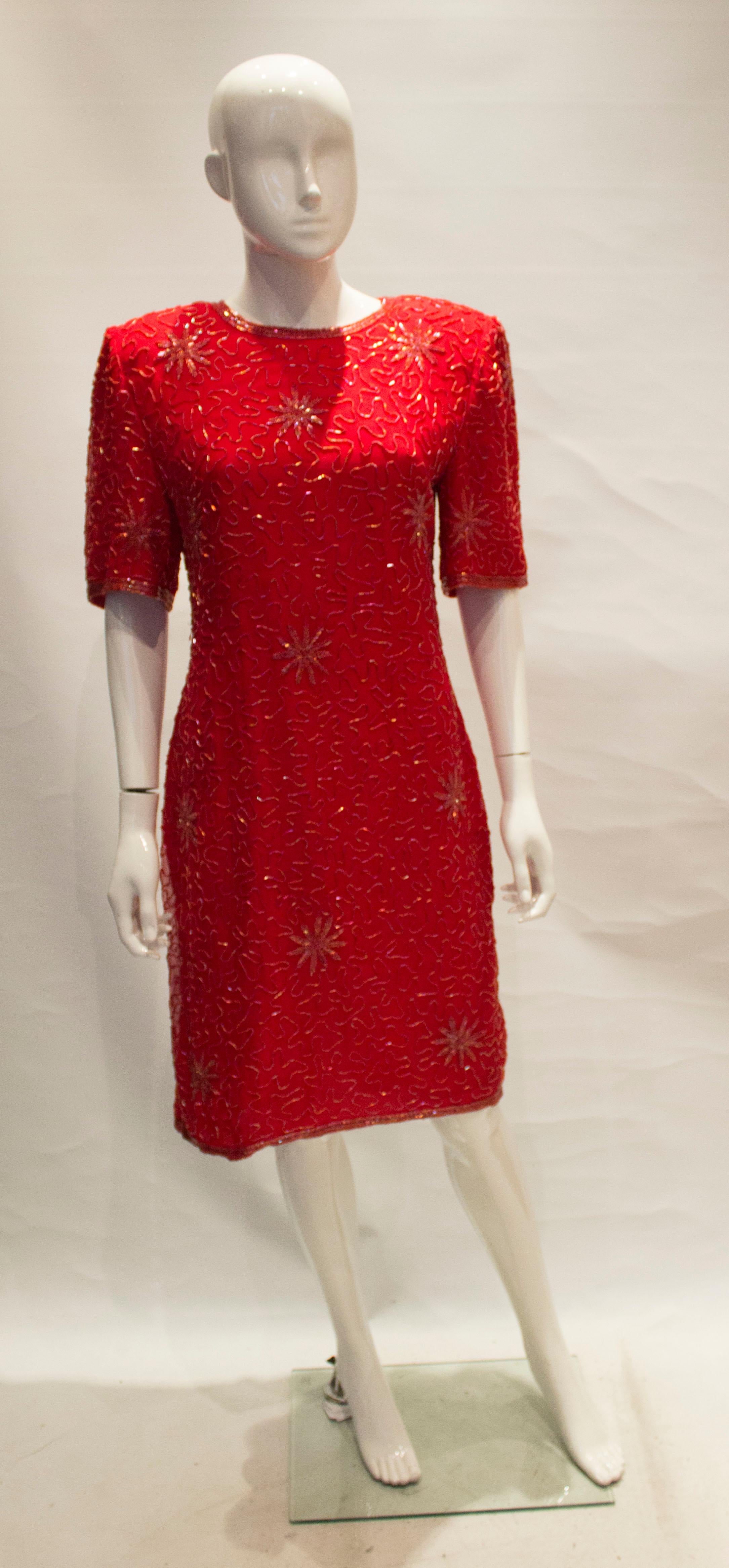 A great vintage cocktail dress for the party season. The dress is silk, with dead detail. It has a key hole opening at the back, with a central back zip and 7'' slit  and shoulder pads that could be removed.