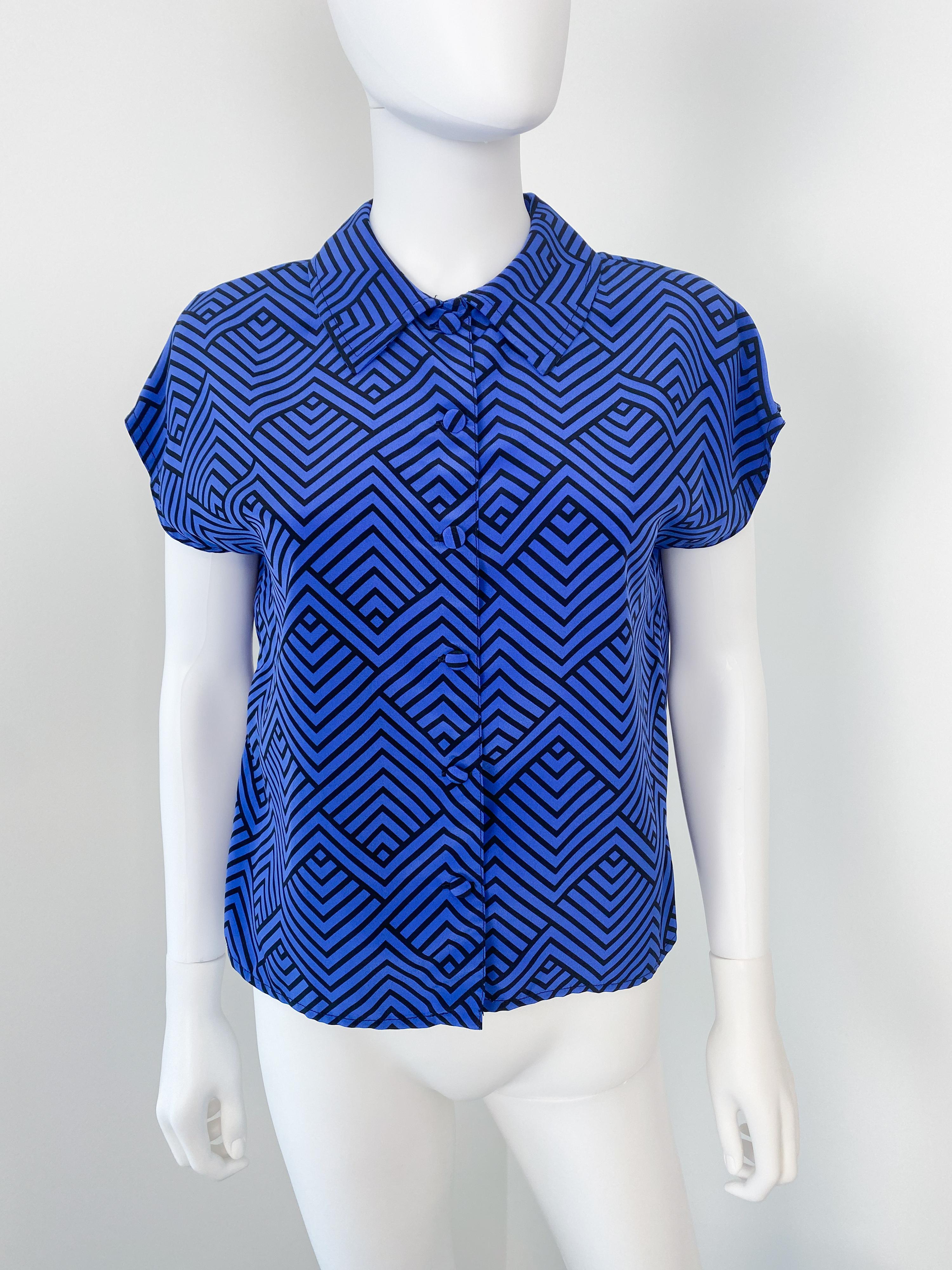 Wonderful vintage 1980s silky polyester pussy bow blouse with original tie. Electric blue and black color fabric with a zig-zag pattern. 
Short sleeves.

Brand: Unknown
Model: Polyester shirt
Material: polyester, synthetic (estimate)
Dominant Color: