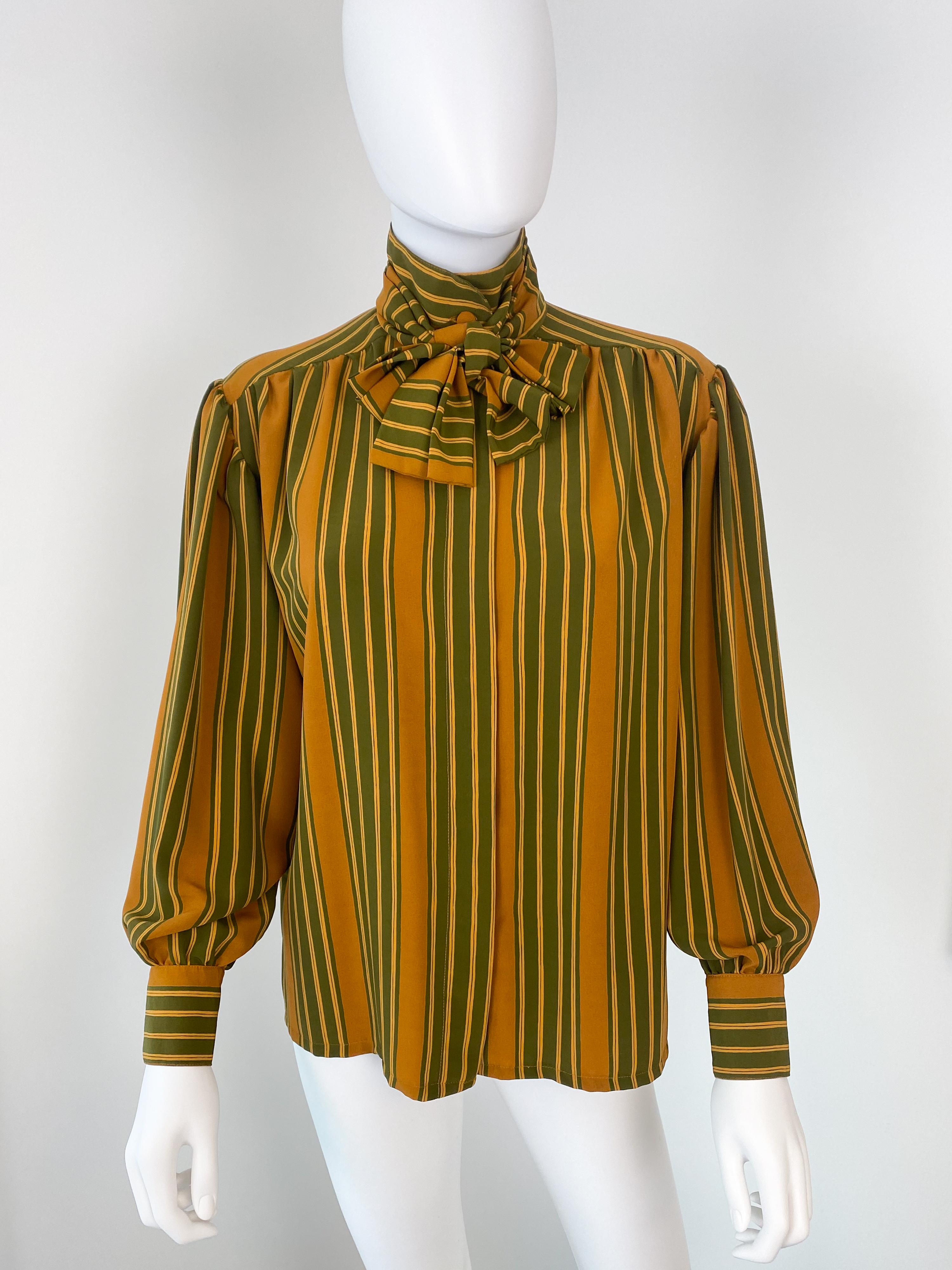 Wonderful vintage 1980s silky polyester pussy bow blouse. Avocado green and saffron yellow color fabric striped pattern. With its original tie. 
There is ample pleating at the back and button cuffs to provide volume. Long sleeves with a cinch at the