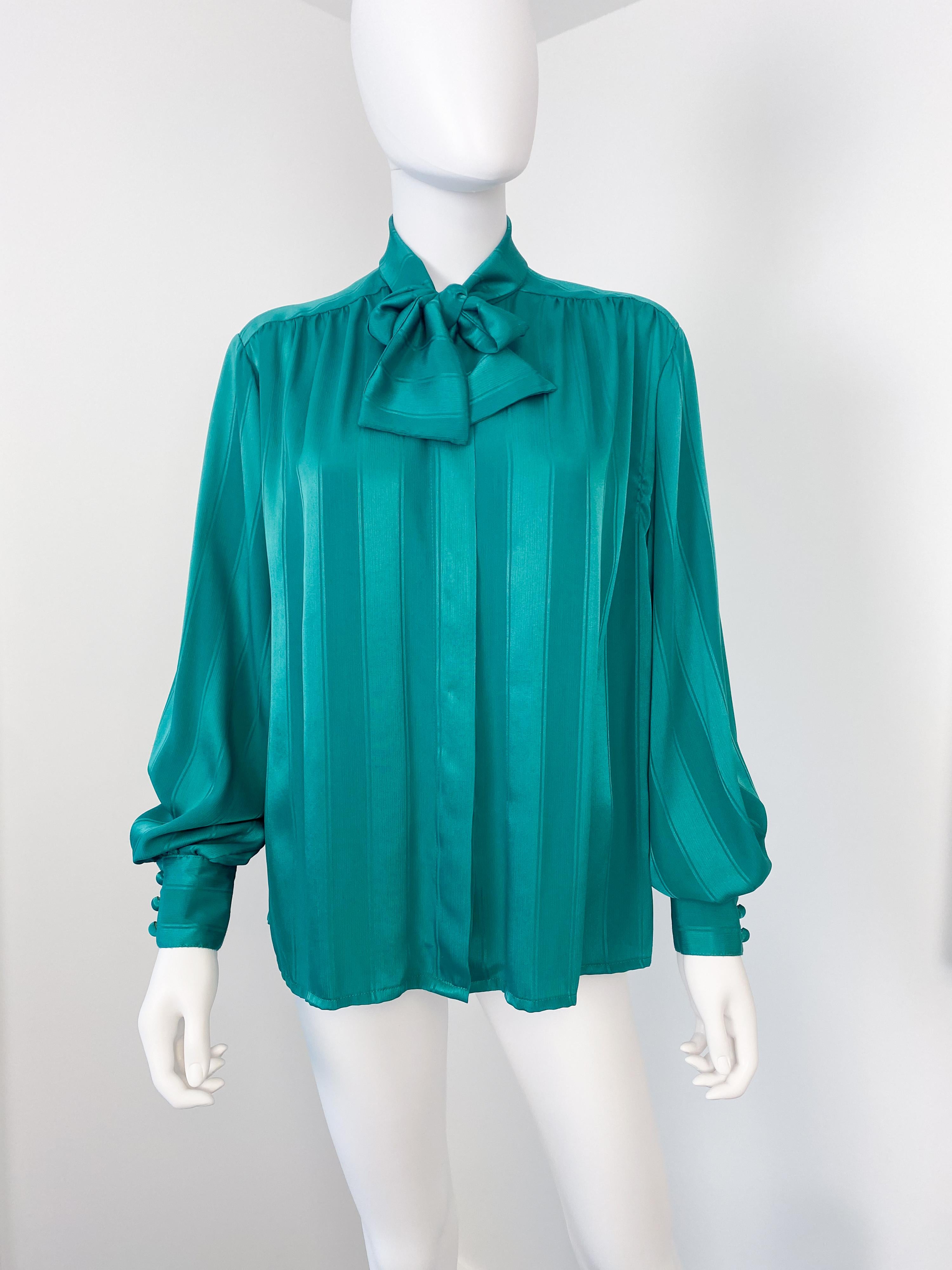 Wonderful vintage 1980s silky polyester pussy bow blouse with attached scarf-bow. Vibrant emerald green color fabric with tone-on-tone geometric striped pattern. There is ample pleating on the front, the back, and the button cuffs to provide