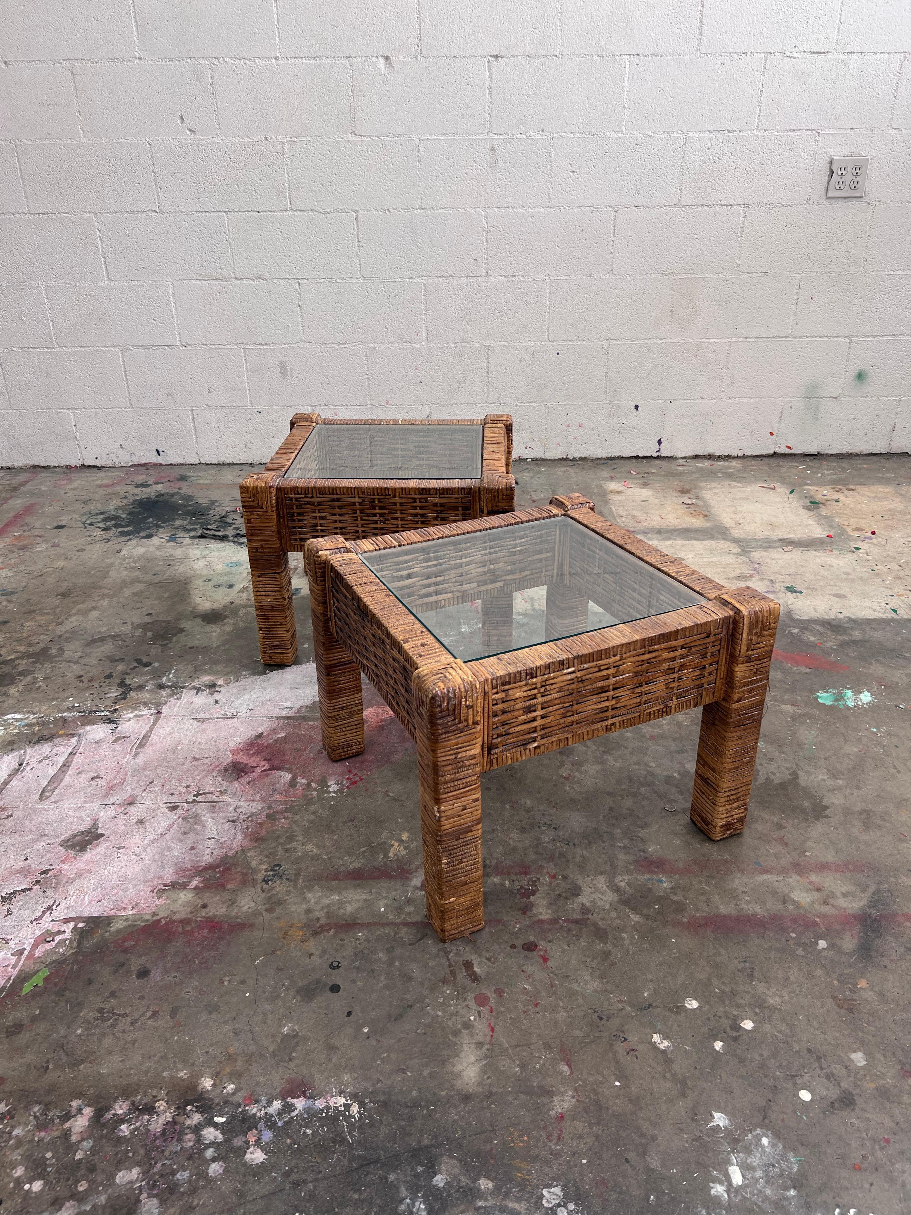 Vintage rattan side or end tables or small coffee table with glass tops. 

Made in America in the late 1980s

A large version of these are also available. 
