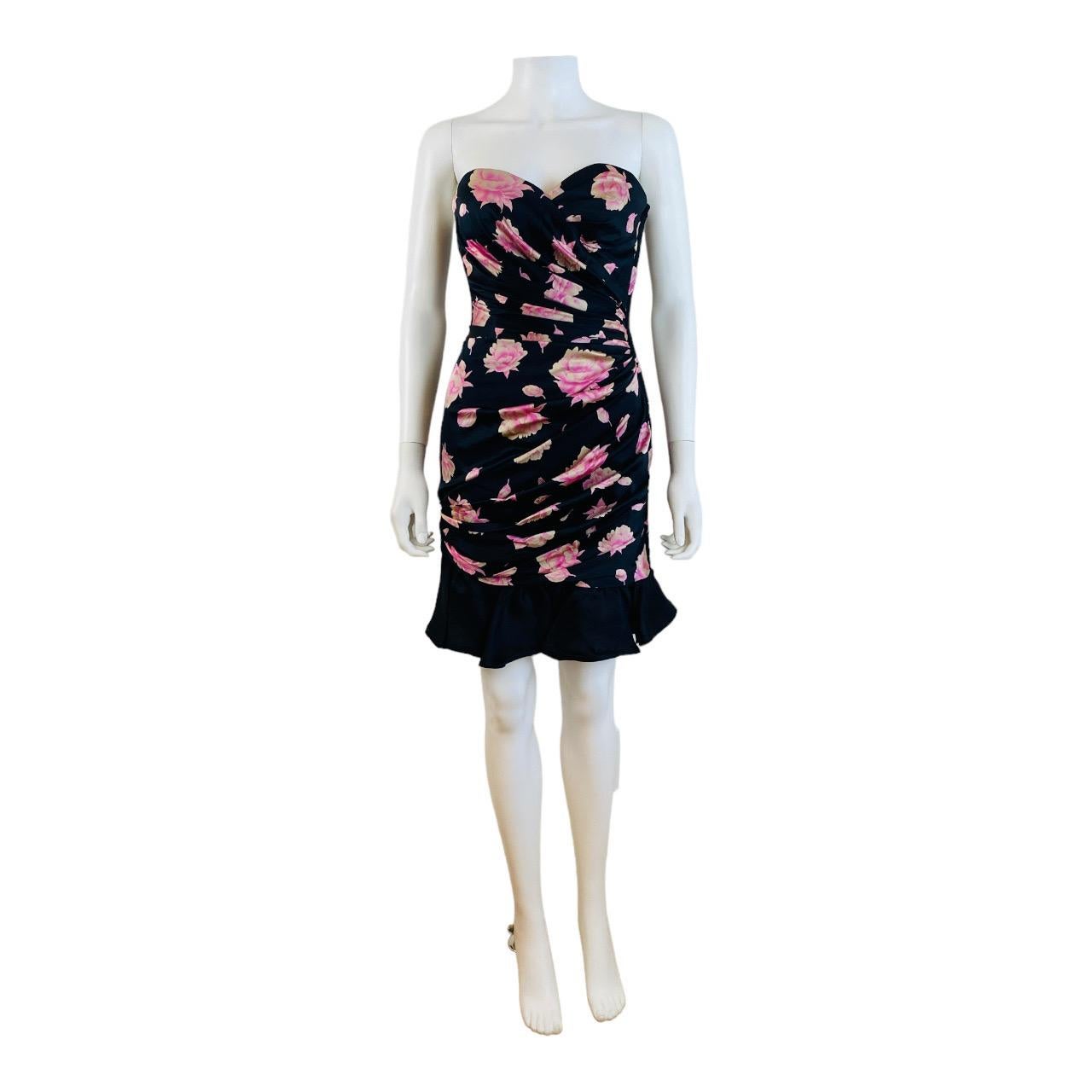 Gorgeous vintage Ungaro dress
Black silk with bright pink roses print throughout
Strapless
Sweetheart neckline
Crossover bust details
Boning on the bodice
Gathered fabric details at the left side at waist
Gathered fabric details on the right side at