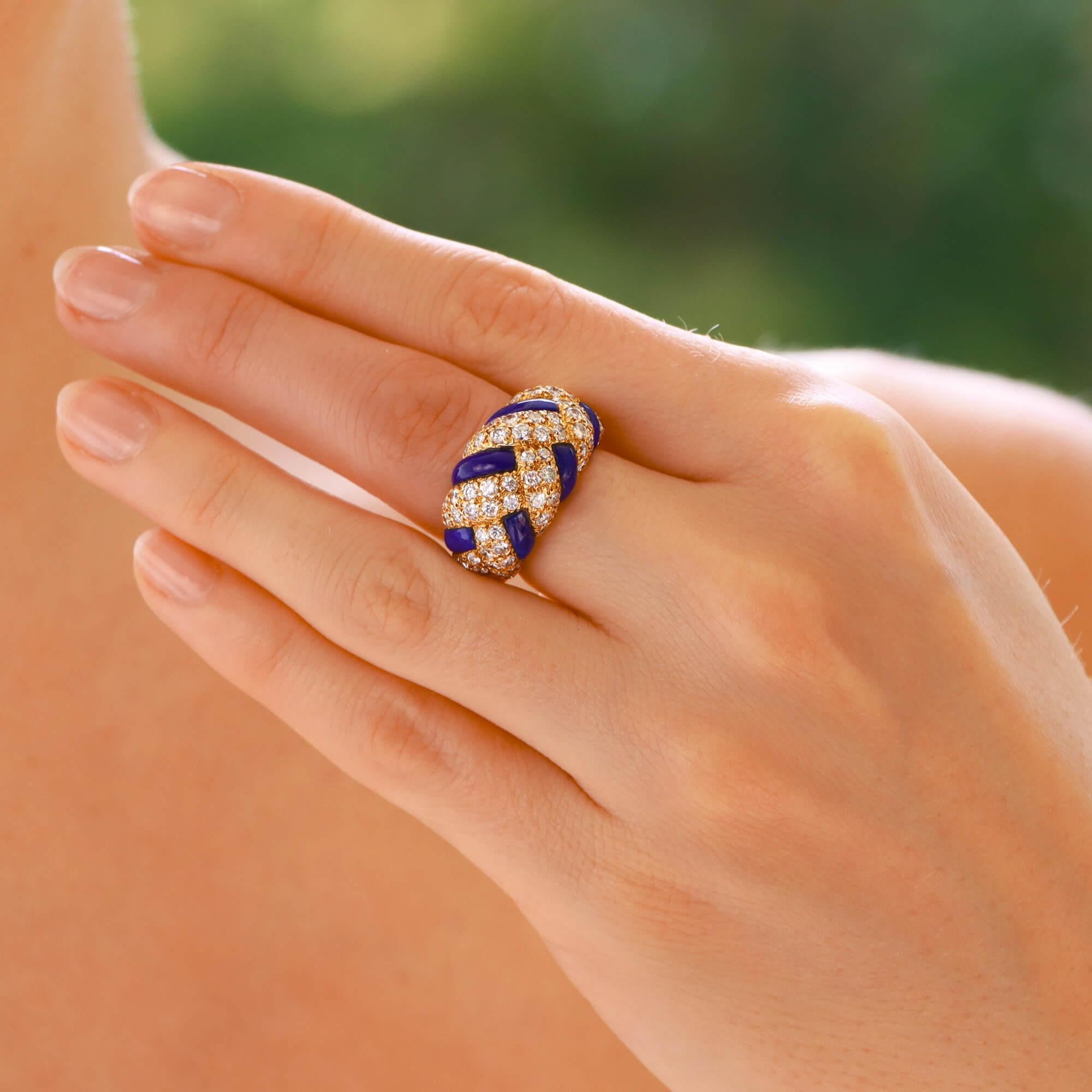 A beautiful vintage Van Cleef and Arpels lapis and diamond bombe dress ring set in 18k yellow gold.

The ring features a unique plaited design composed of lapis lazuli and pave set diamond panels. The contrast of the Royal blue lapis against the