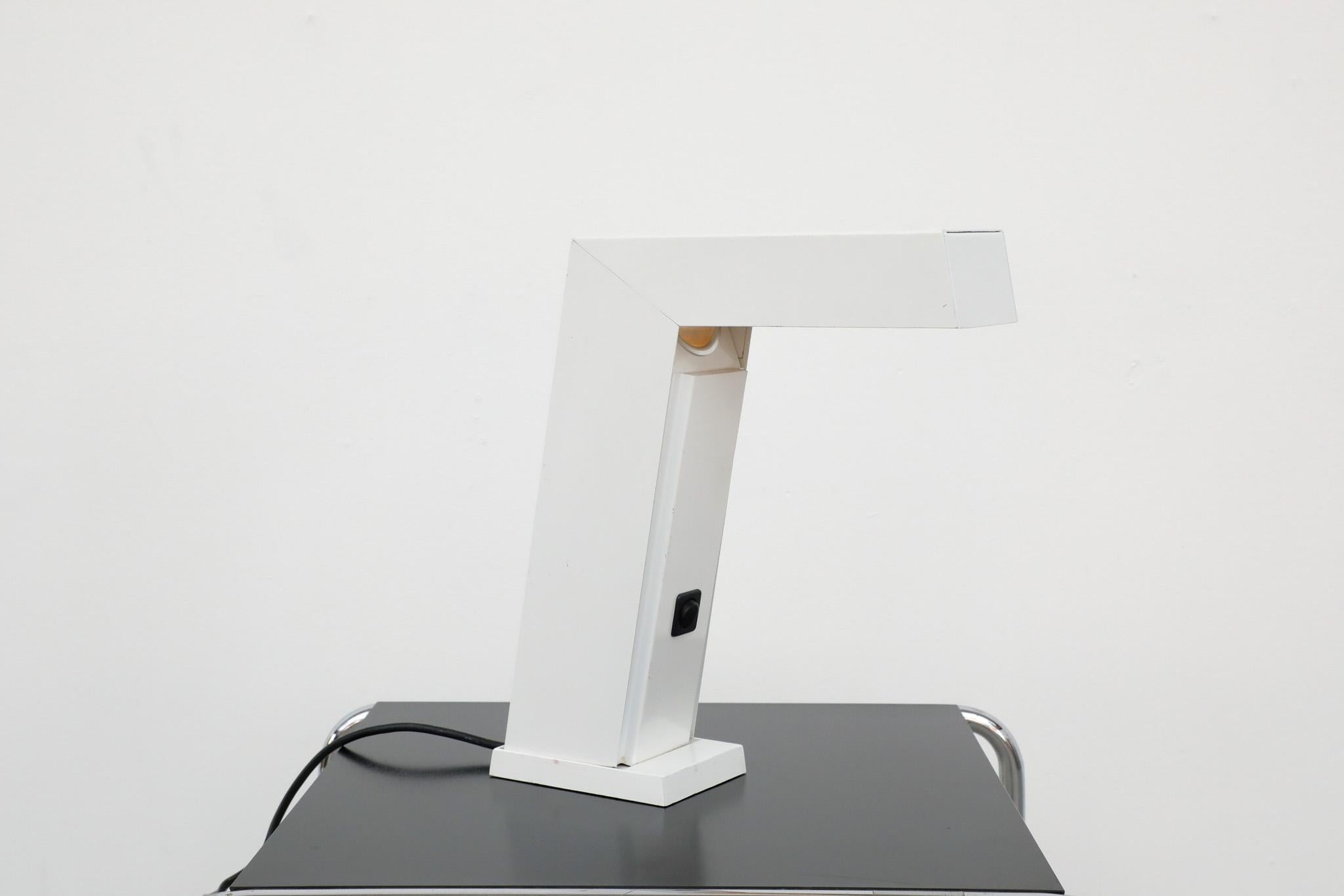Vintage 'Work-Sun' halogen desk lamp by Euro licht, 1983. An IF Design Award winner with white enameled metal frame and contrasting black power button. Geometric lines and minimalist design. In original condition with light age appropriate wear