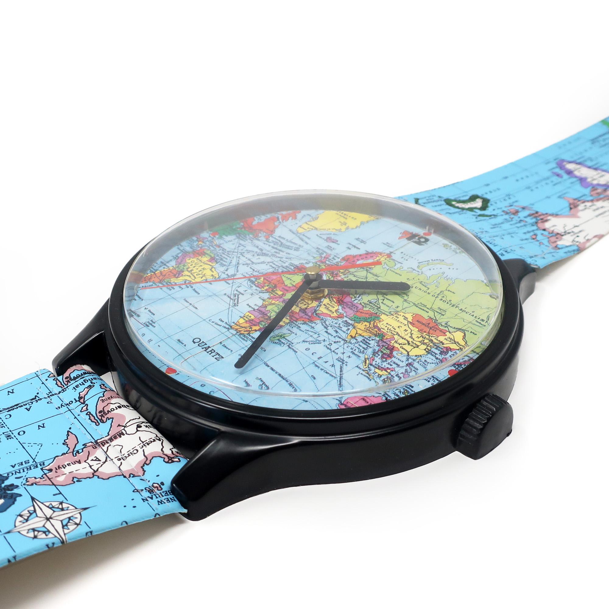 A vintage world map wrist watch shaped wall clock from the 1980s. Looks exactly like a wrist watch blown up to fit a giant's wrist! Just under four feet tall, this amazing clock has oversized bands, buckle, and face, all printed with a world map