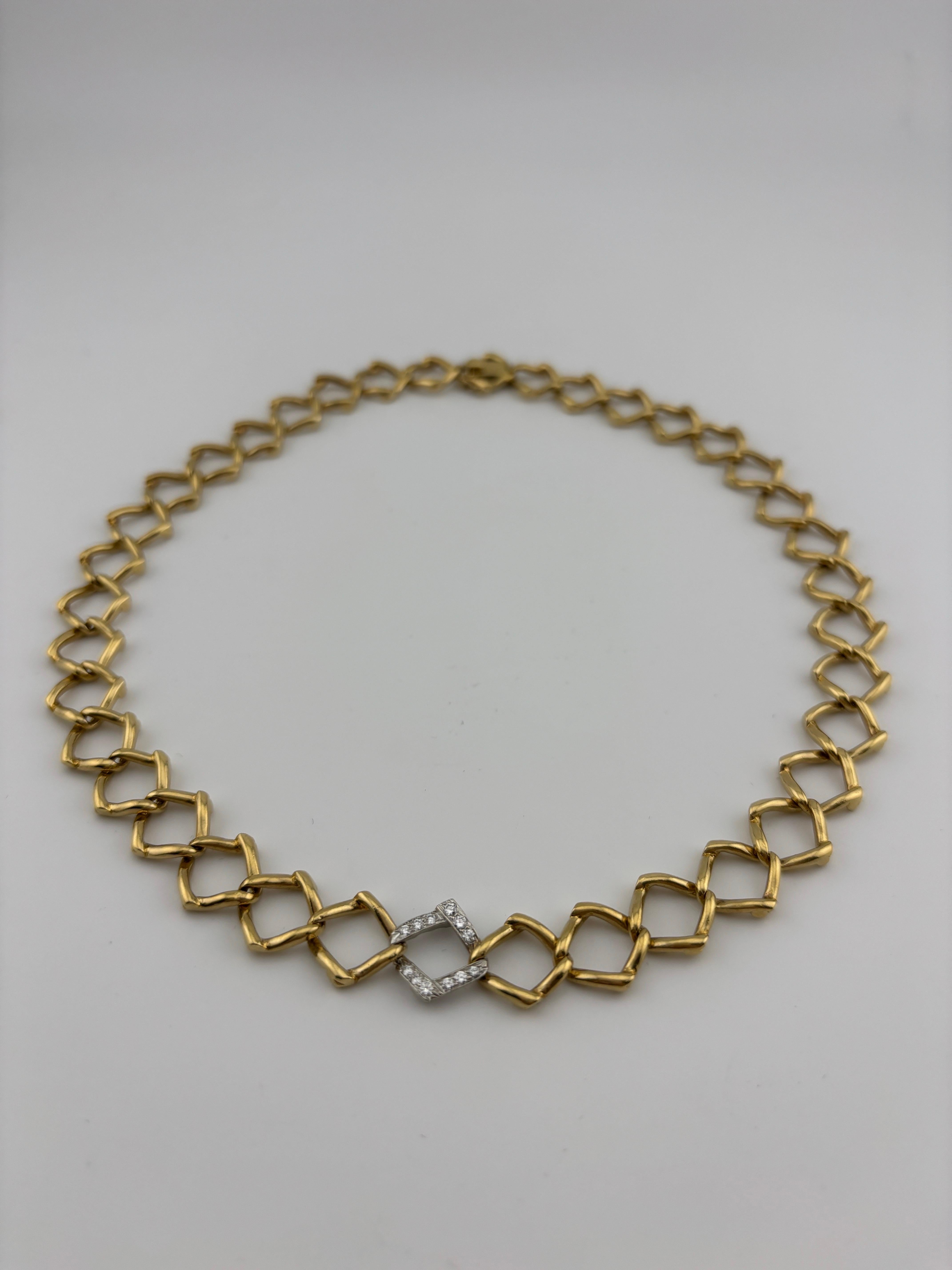 This exquisite necklace, designed by Paloma Picasso for Tiffany & Co., showcases a sophisticated and modernist open-link design crafted in luxurious 18k yellow gold. The center link is meticulously paired with round brilliant cut diamonds and