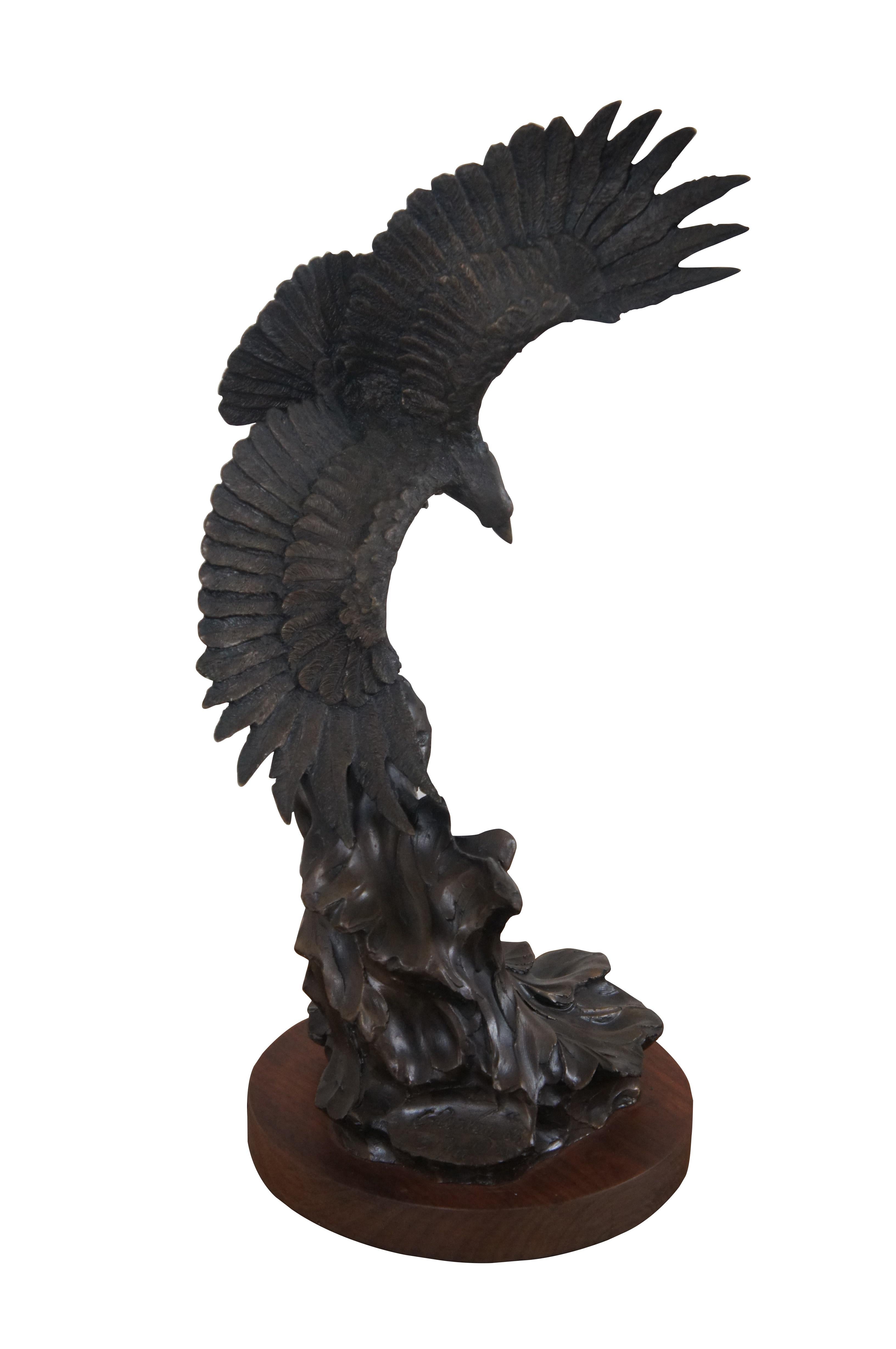 Vintage bronze sculpture depicting a realistically detailed American Bald Eagle / hawk / bird swooping over abstract waves, mounted on a round wood base. Signed on base C. Ra. Van 1983. Numbered 31/50.

Dimensions:
6.5