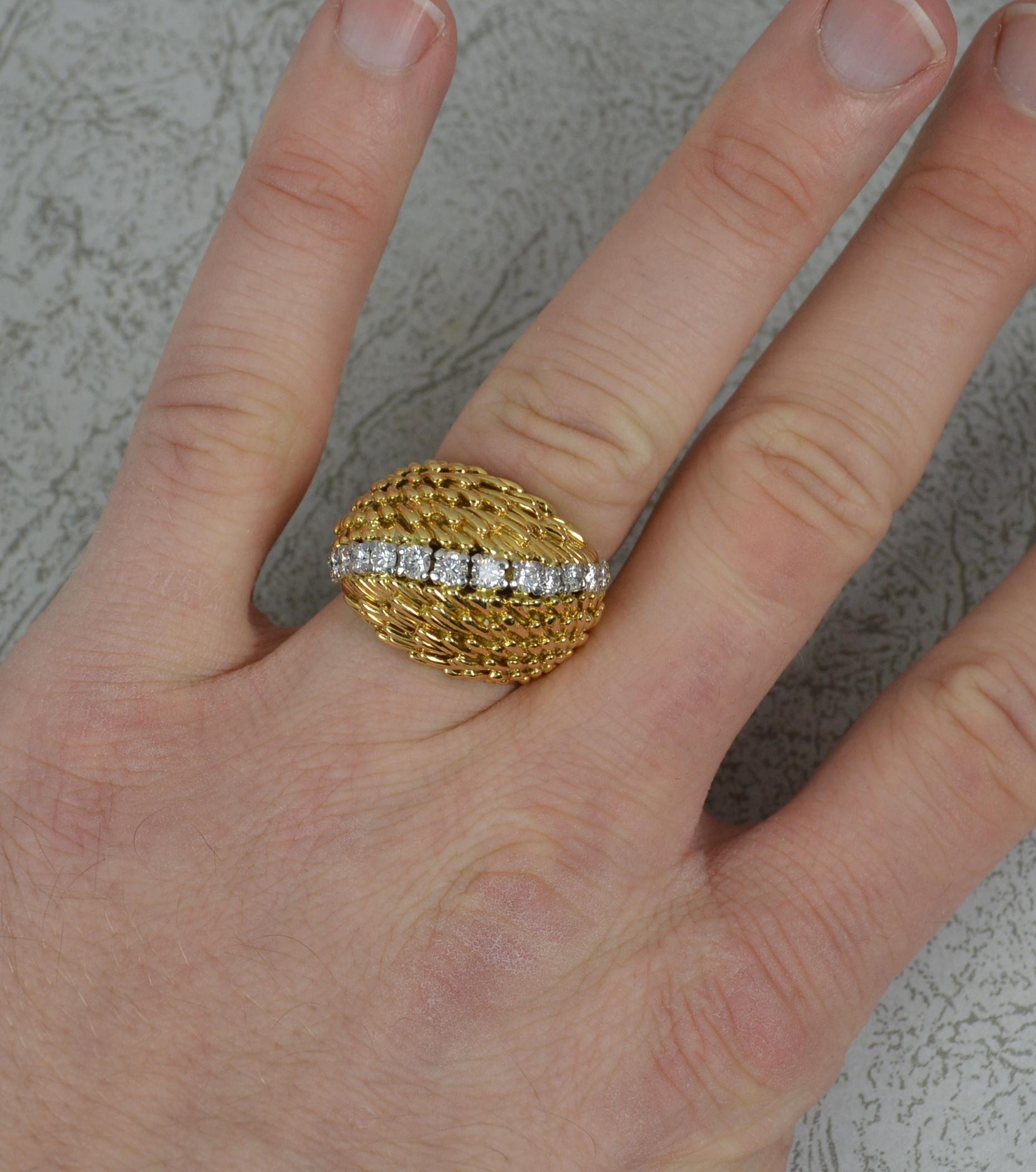 A stunning Kutchinsky ring.
Solid 18 carat yellow gold ring with white gold claw setting for the diamonds.
Designed with fifteen natural, round brilliat cut, diamonds set onto a diagonal. Just under 1 carat total. Vs clarity, G-H colour.
The heavy