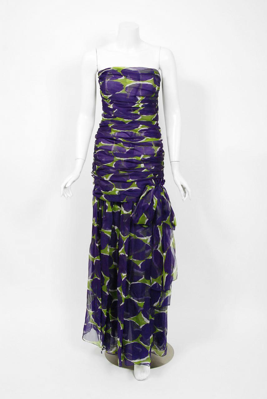 Breathtaking purple and green abstract print doumented gown from the infamous Rive Gauche collection of 1983. The dress is made from layers of a light silk voile that feels almost weightless when worn. I adore the abstract color combination of