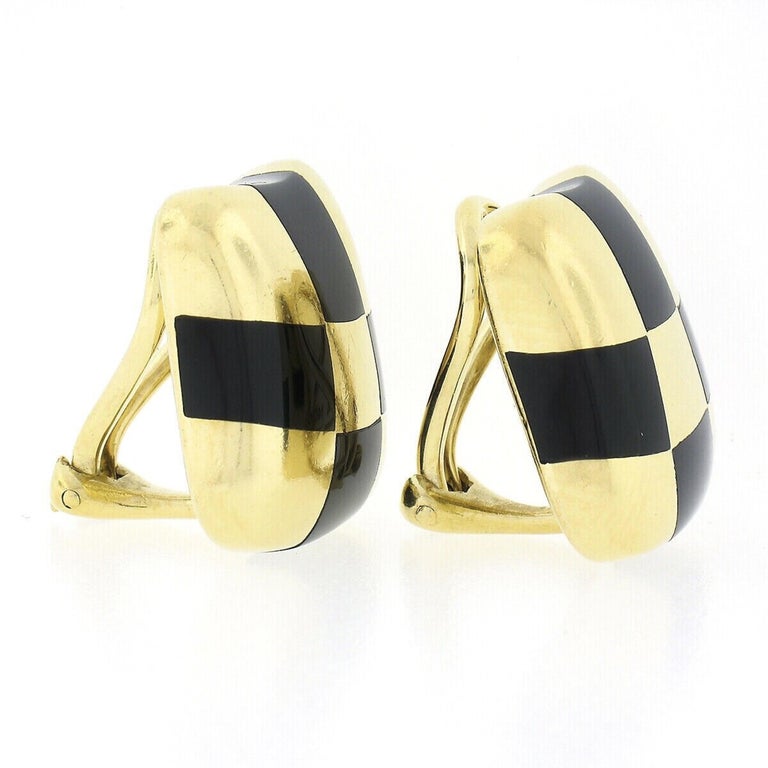 Here we have a beautiful pair of vintage button style earrings by Angela Cummings that were crafted in 1984 from solid 18k yellow gold. They feature a bold and wavy design that is neatly inlaid set with custom cut black onyx stones in a checkerboard