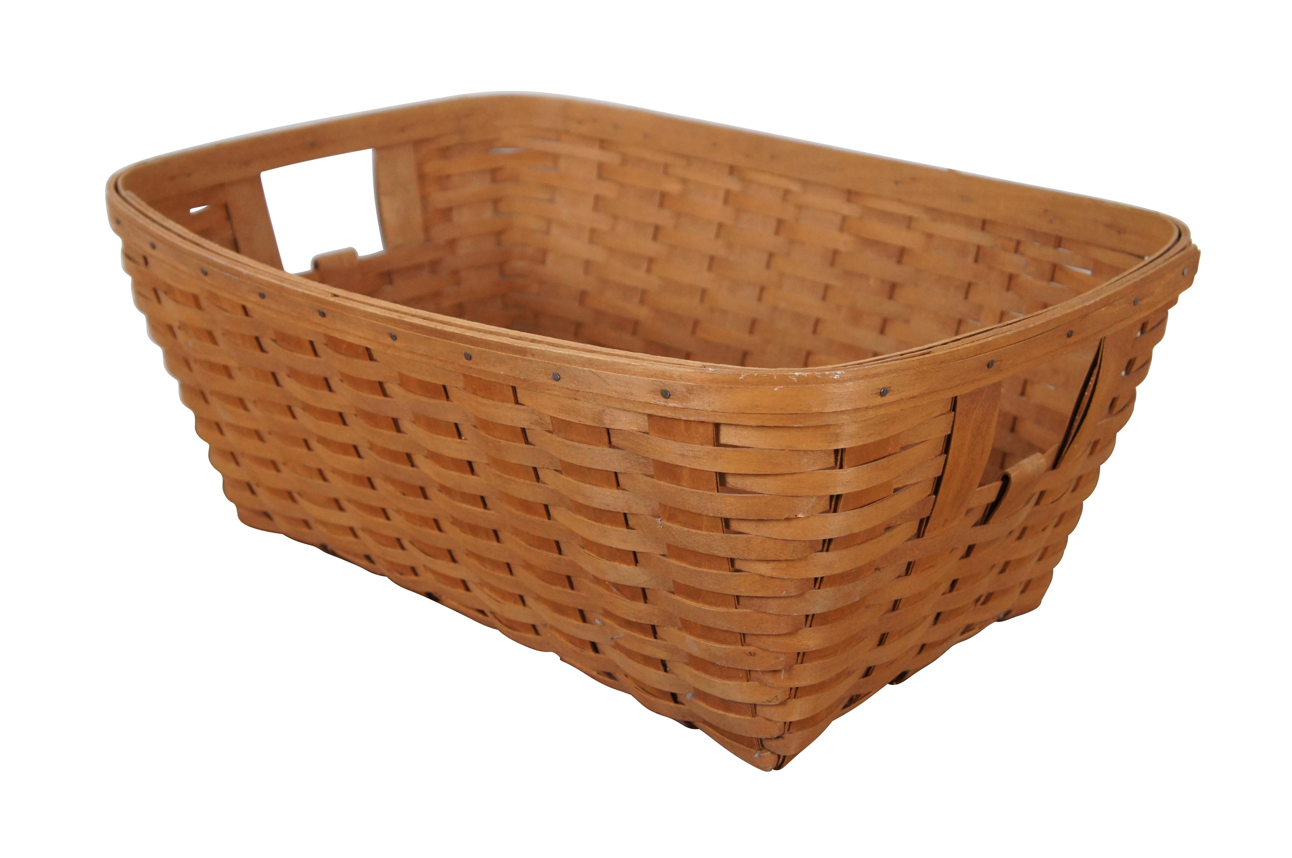 Vintage 1980’s Longaberger laundry basket, handwoven maple wicker with a rectangular form, tapered base, and open handles. No liner. Item number 2600-0. Signed J.W. 1987 on base.

“The Longaberger Company was an American manufacturer and distributor