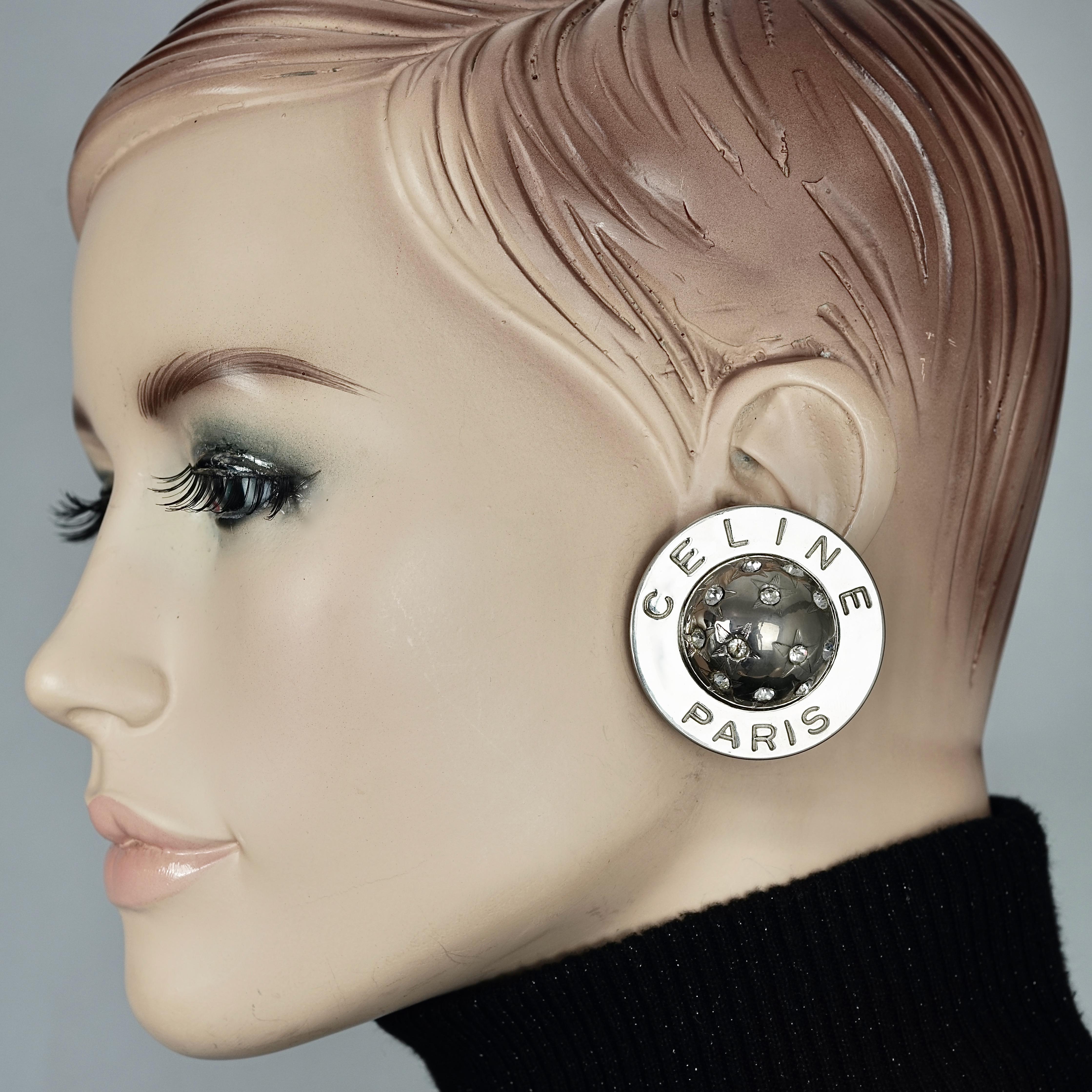 Vintage 1989 CELINE PARIS Rhinestone Planet Sphere Earrings

Measurements:
Height: 1.69 inches  (4.3 cm)
Width: 1.69 inches  (4.3 cm)
Depth: 0.55 inch (1.4 cm)
Weight per Earring: 25 grams

Features:
- 100% Authentic CELINE PARIS.
- Round earrings
