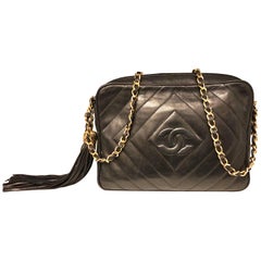Vintage 1989 to 1991 Chanel black lambskin camera bag with tassel.