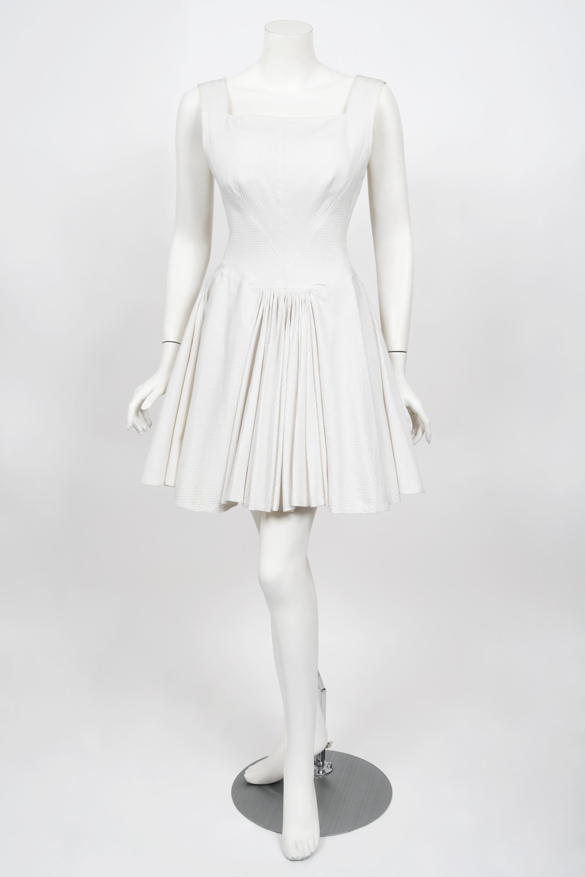 Incredibly chic ivory white waffle-cotton skater mini dress from Azzedine Alaia's 1990 spring/summer collection. This dress is so iconic and would be a wonderful beach resort or bridal look! Alaïa introduced the world to the 'body' and to his own