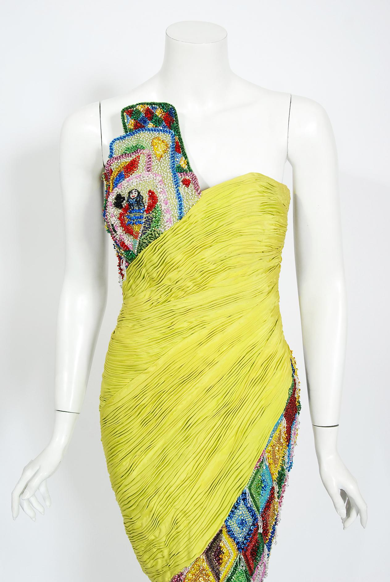 An exceptional and museum quality Gianni Versace multi-colored beaded mini dress dating back to his iconic Spring/Summer 1990 runway couture collection. This one-of-a-kind dress debuted in Paris and has been authenticated by their historical