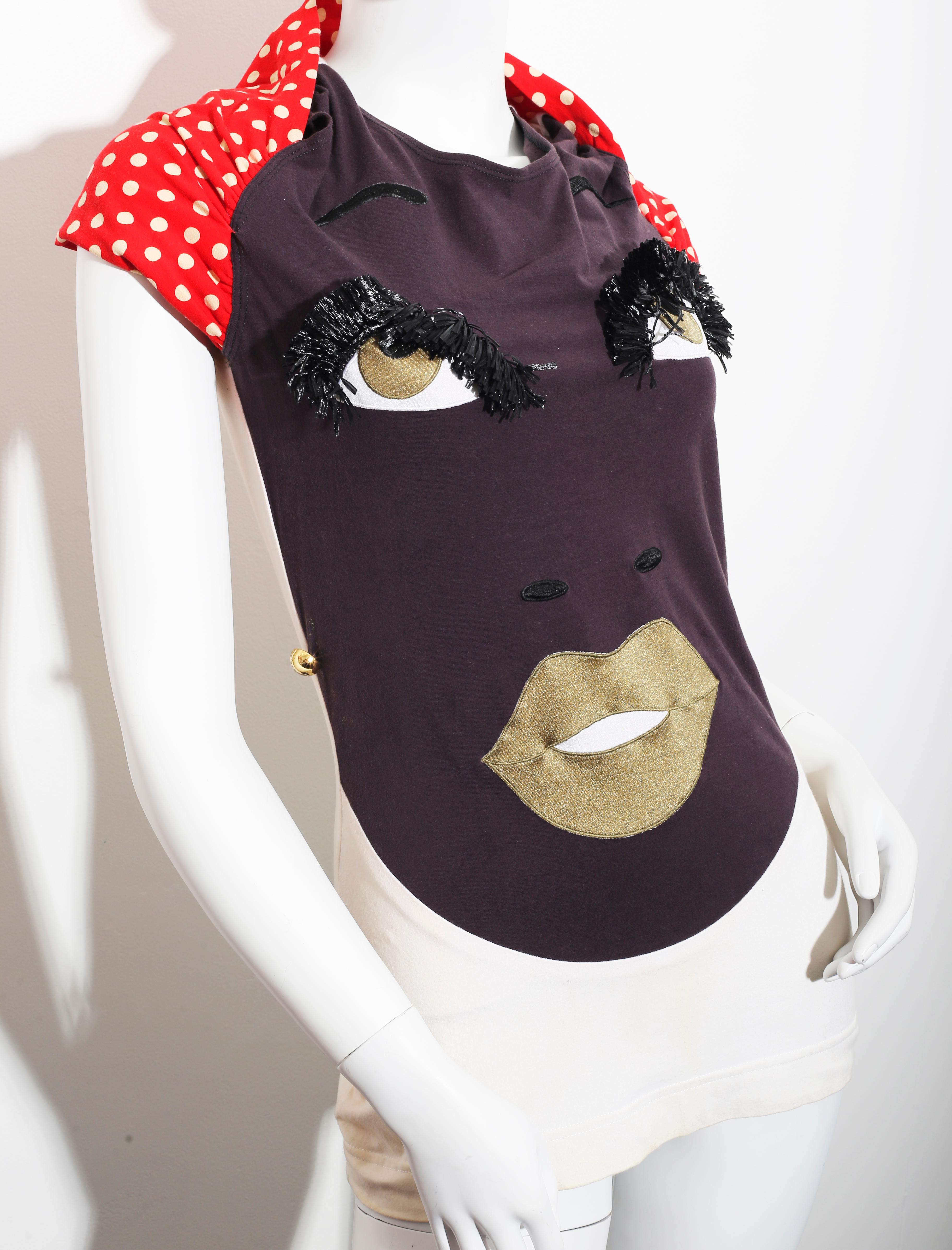  Vintage 1990´s Moschino Polkadots sexy eyes and mouth face shirt 
Made in Italy
Marked Size Italy 42 US 8 can fit smaller sizes too since textile is  stretch
Length 52cm, inches 20,47 
Moschino  brand was originally created in 1983 by the late