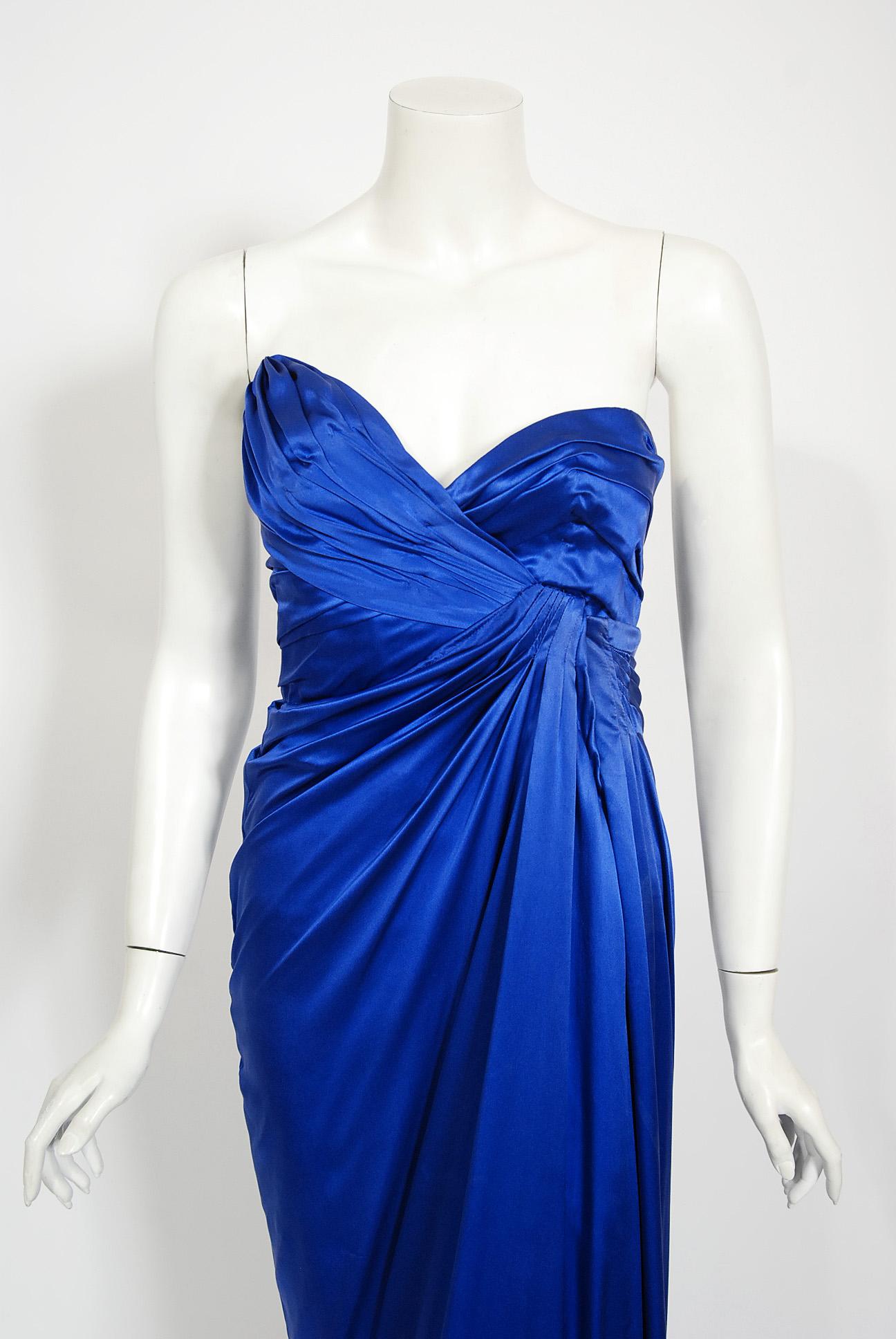 An iconic and well documented Thierry Mugler 1990 fall-winter sapphire blue silk corset strapless gown with original $6500 price tag attached. With inflation, that would be over $15,000 today. This legendary French fashion designer is known for bold