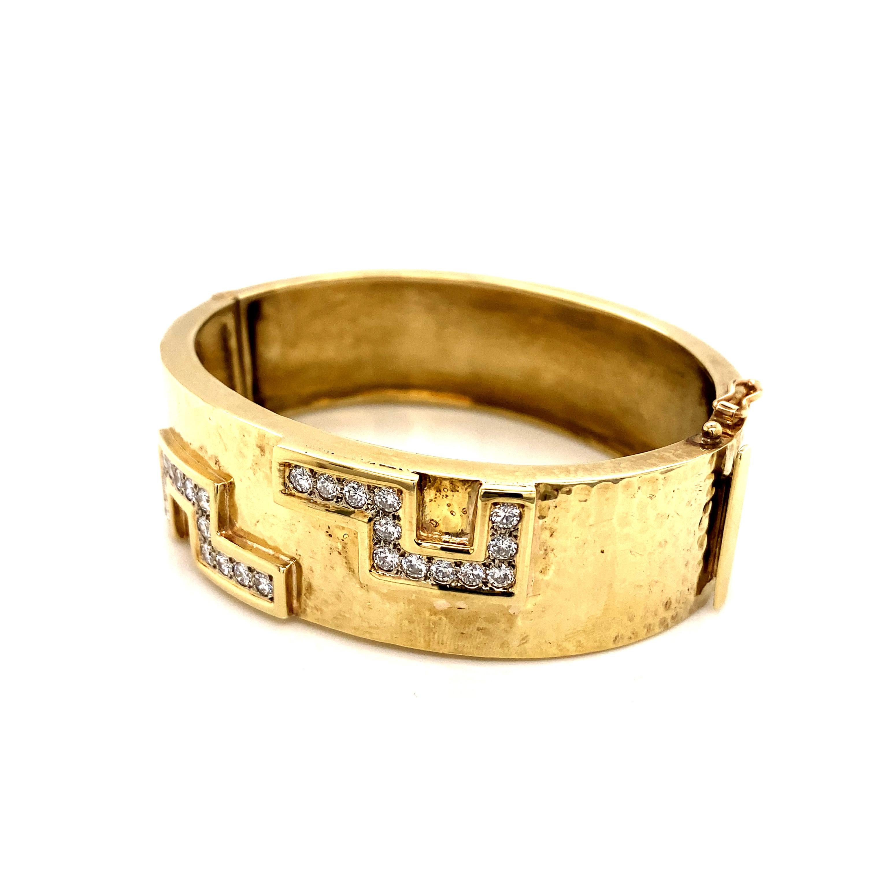 A true statement piece from the 1990s, this stunning 14k yellow gold bangle exudes timeless luxury and glamour. The substantial bracelet features a wide, substantial band that measures an impressive 0.75 inches (1.9 cm) in width for an eye-catching