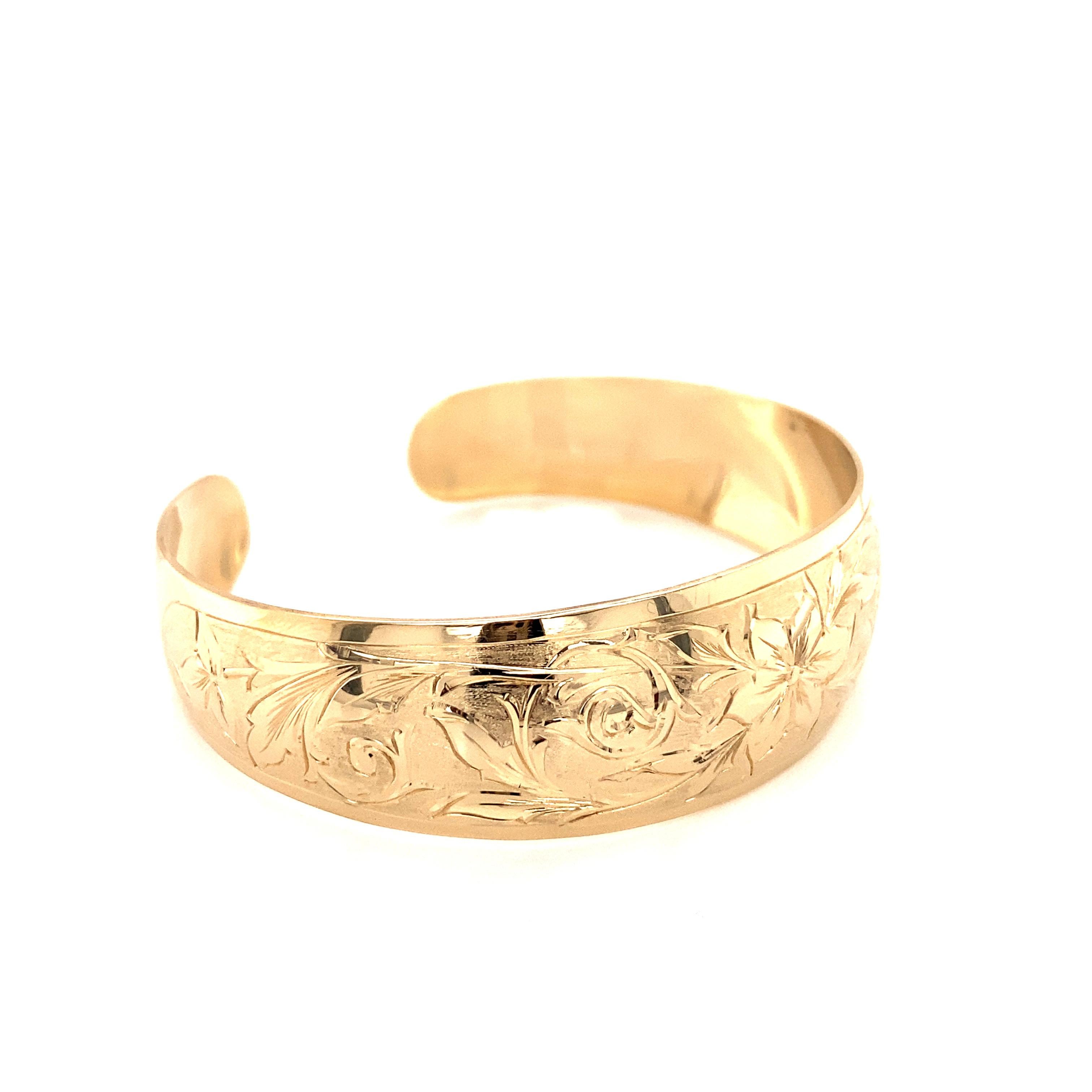 Vintage 1990’s 14k yellow gold hand engraved wide cuff bangle bracelet. The cuff measures 3/4