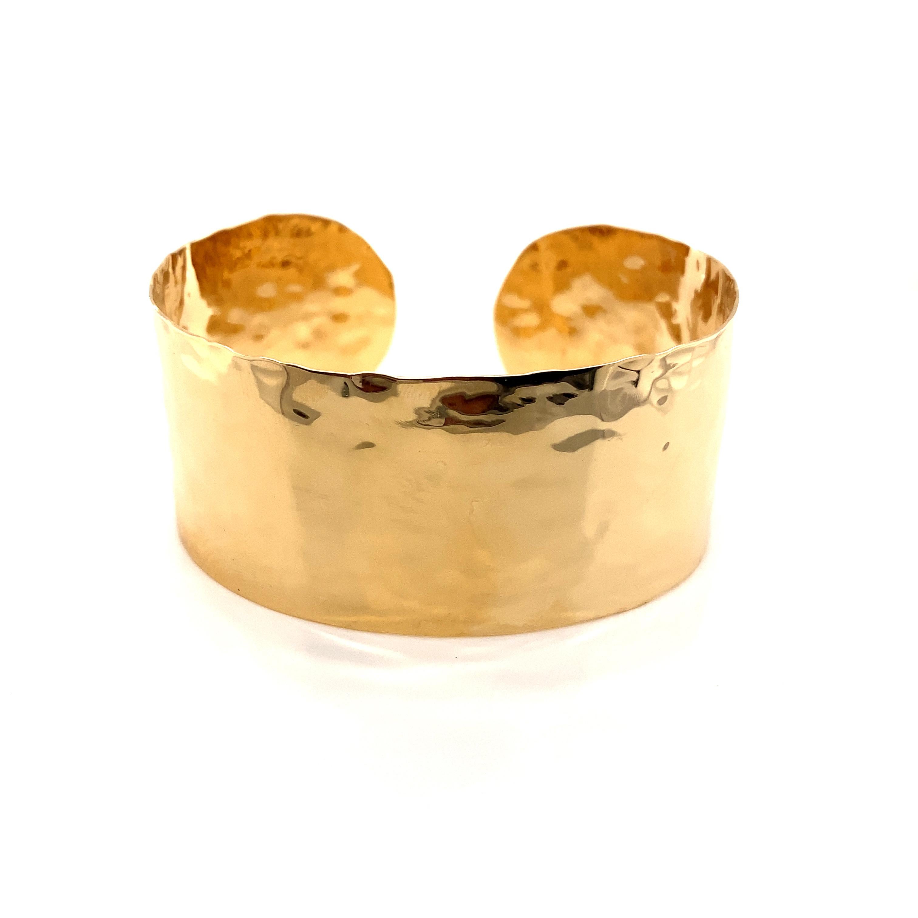 Vintage 1990’s 14k yellow gold wide hammered cuff bangle bracelet. The cuff measures just over 1 inch wide and weighs 23.25g.