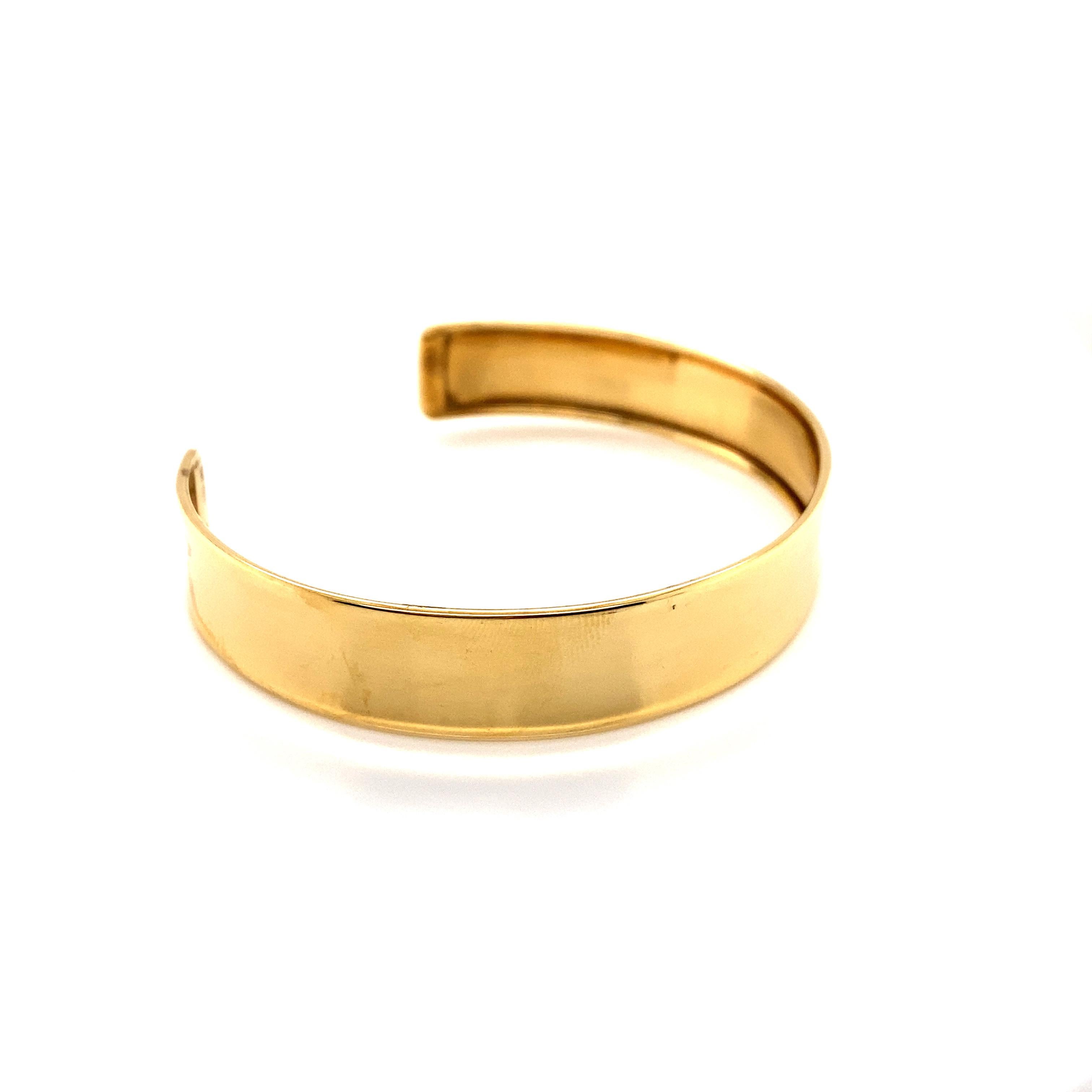 Vintage 1990’s 14k yellow gold cuff bangle bracelet. The cuff bangle measures 1/2
