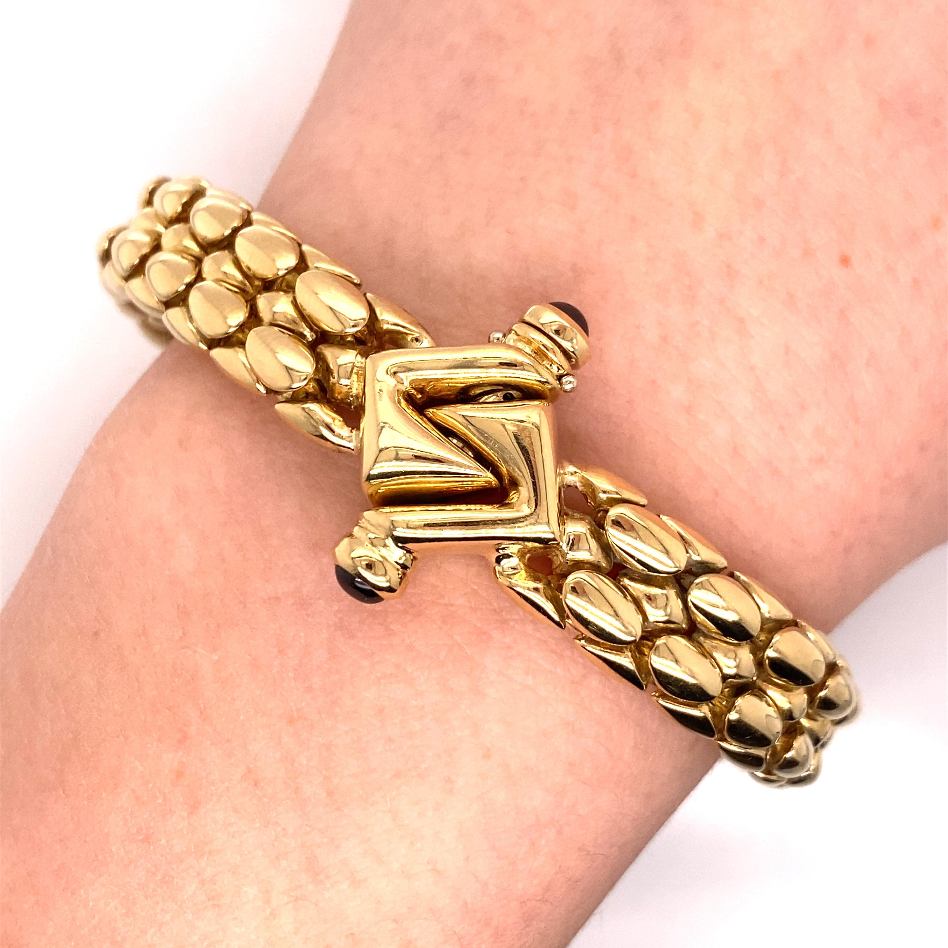 Vintage 1990's 18K Yellow Gold Italian Made Snake Skin Design Bracelet - The bracelet measures 3/8 inches wide and 7 1/2 inches long. The fancy clasp can be worn on the top or the bottom and features 2 cabuchon rubies. The bracelet feels very solid